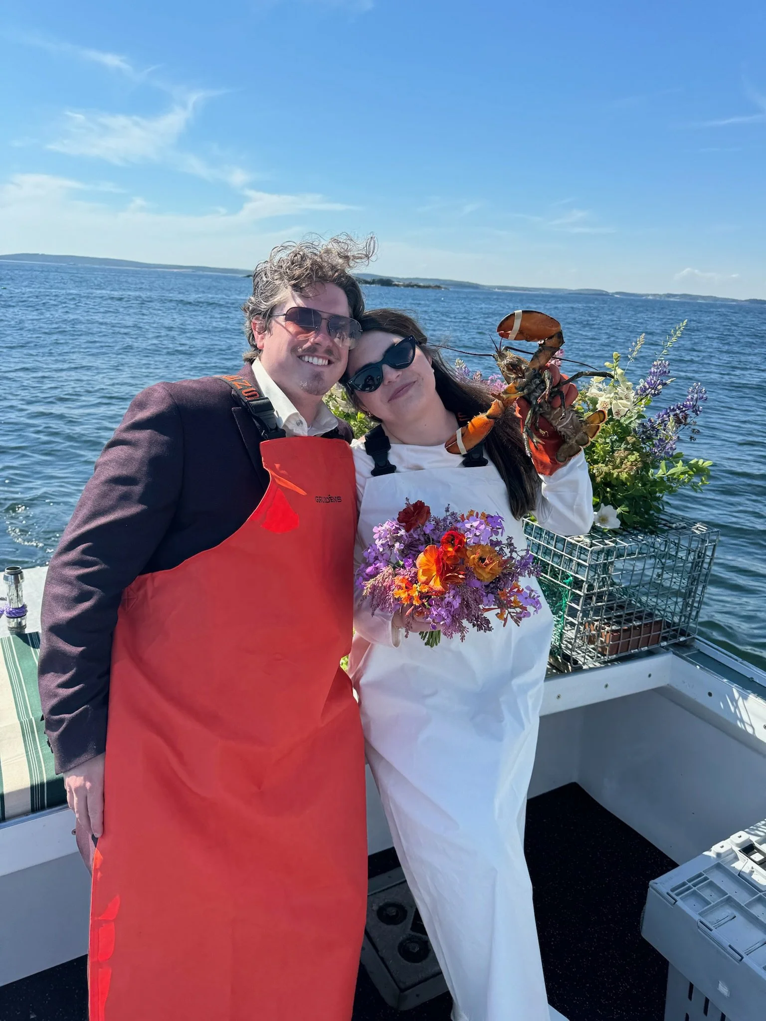 bride and groom celebrating elopement with guests on water