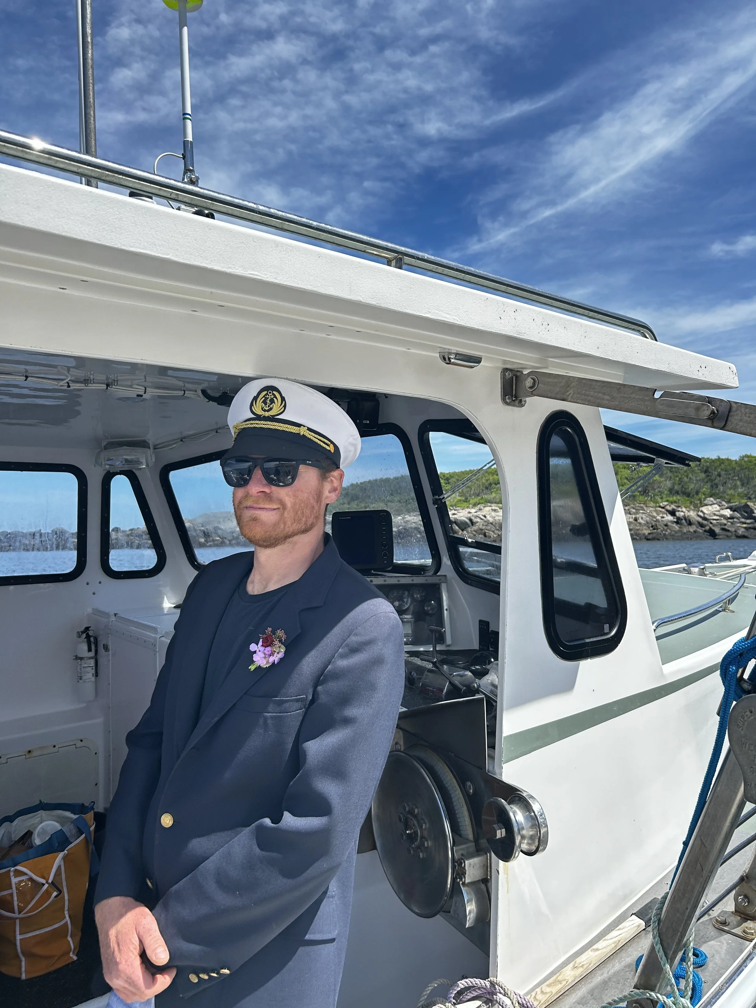 captain ethan standing by on the boat at seguin island