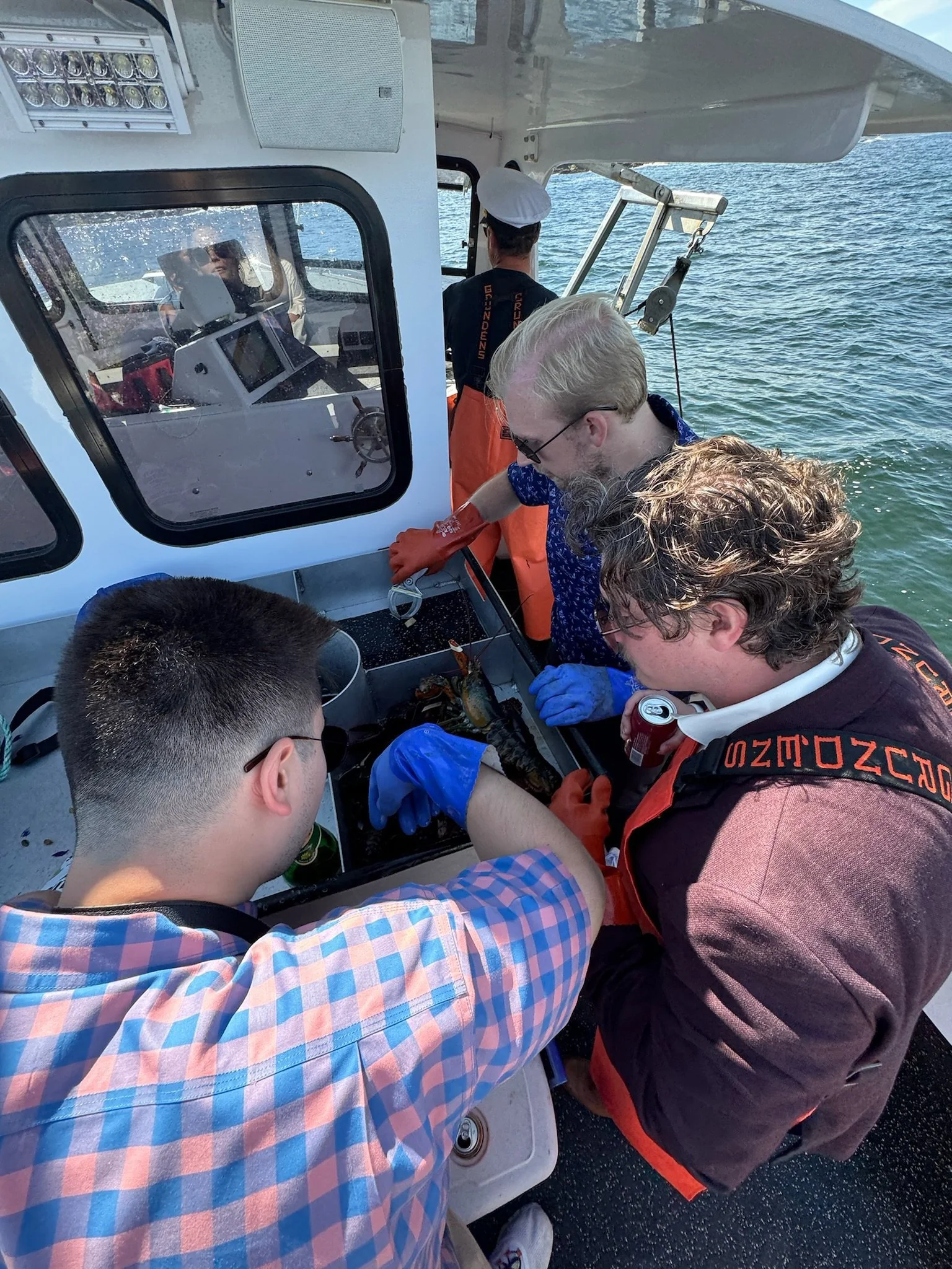 guests learning lobstering during Maine boat wedding