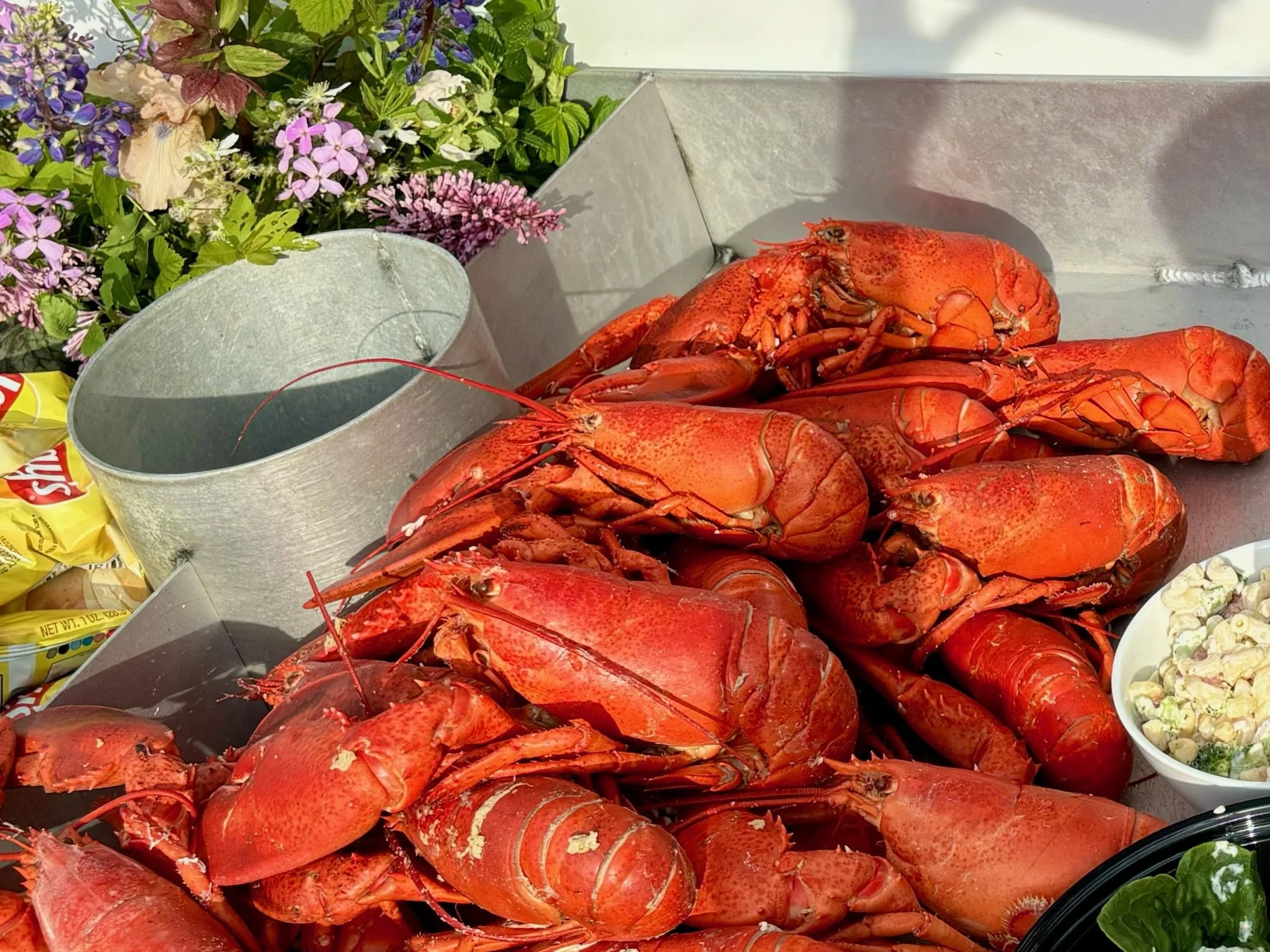 fresh lobster bake prepared on boat for wedding celebration
