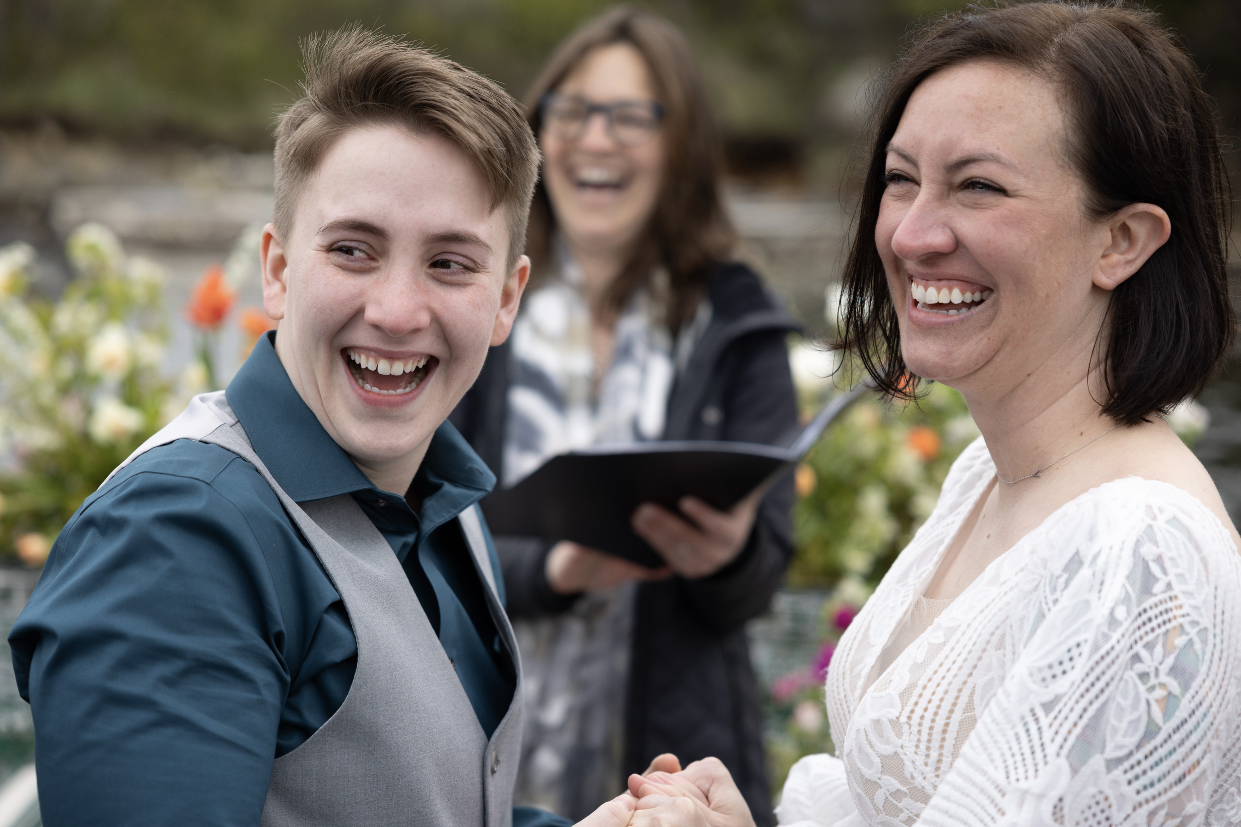 couple laughing on rocky coast in Maine