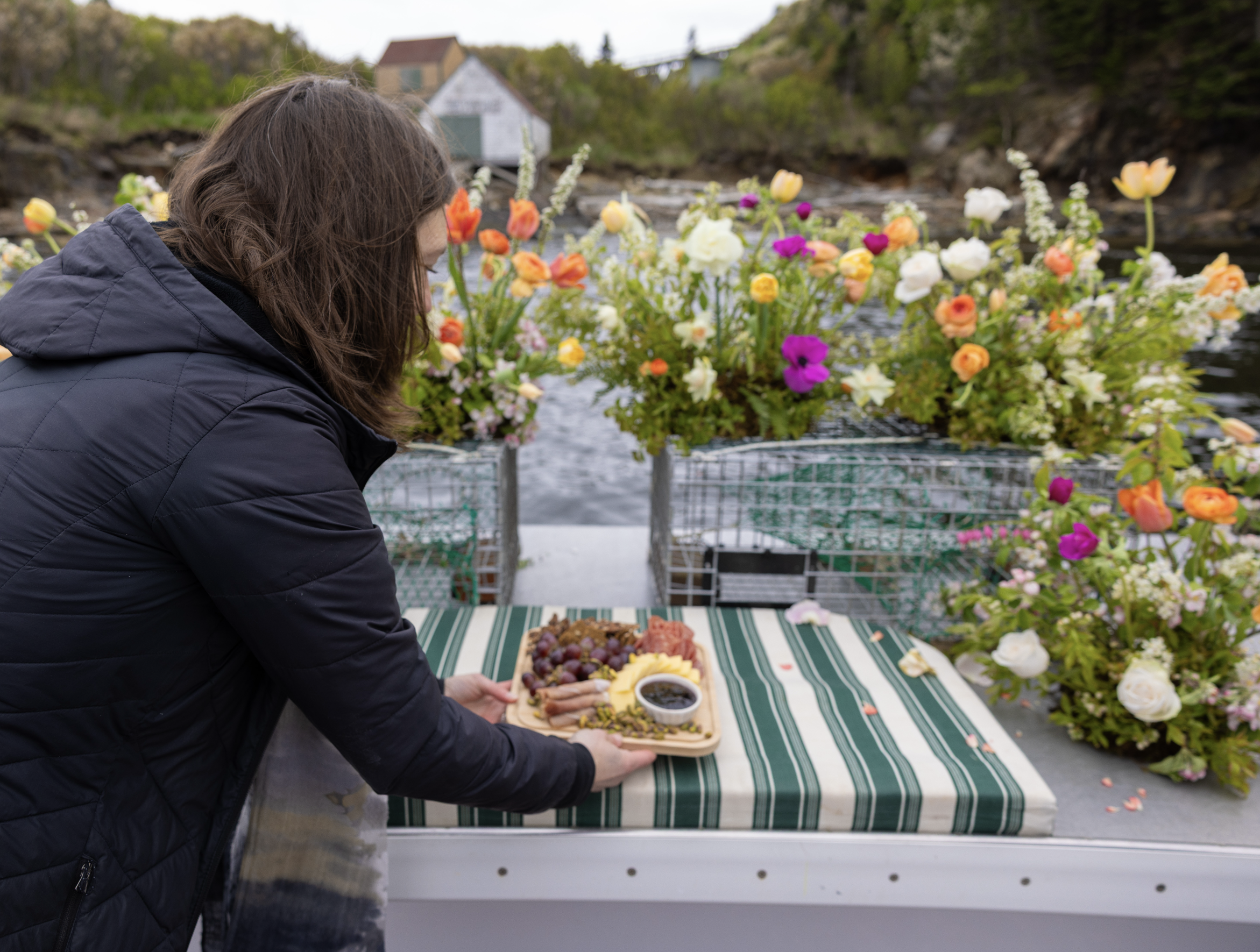 crew placing charcuterie board after wedding ceremony