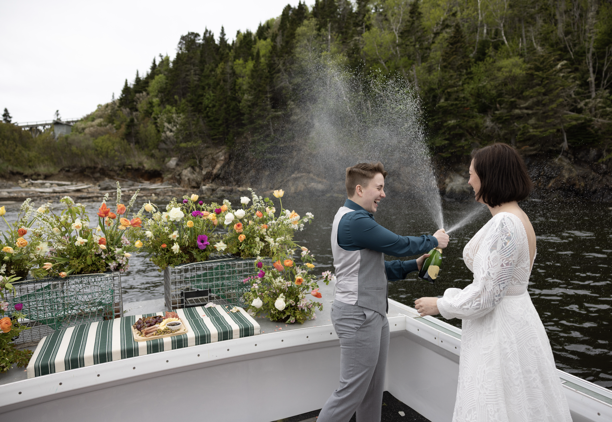 spraying champagne celebrating maine's adventure elopement