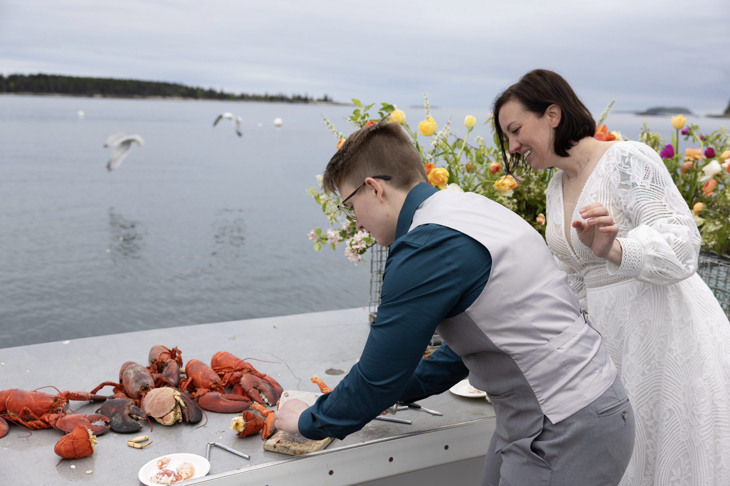 intimate lobster bake on boat after adventure elopement in Maine
