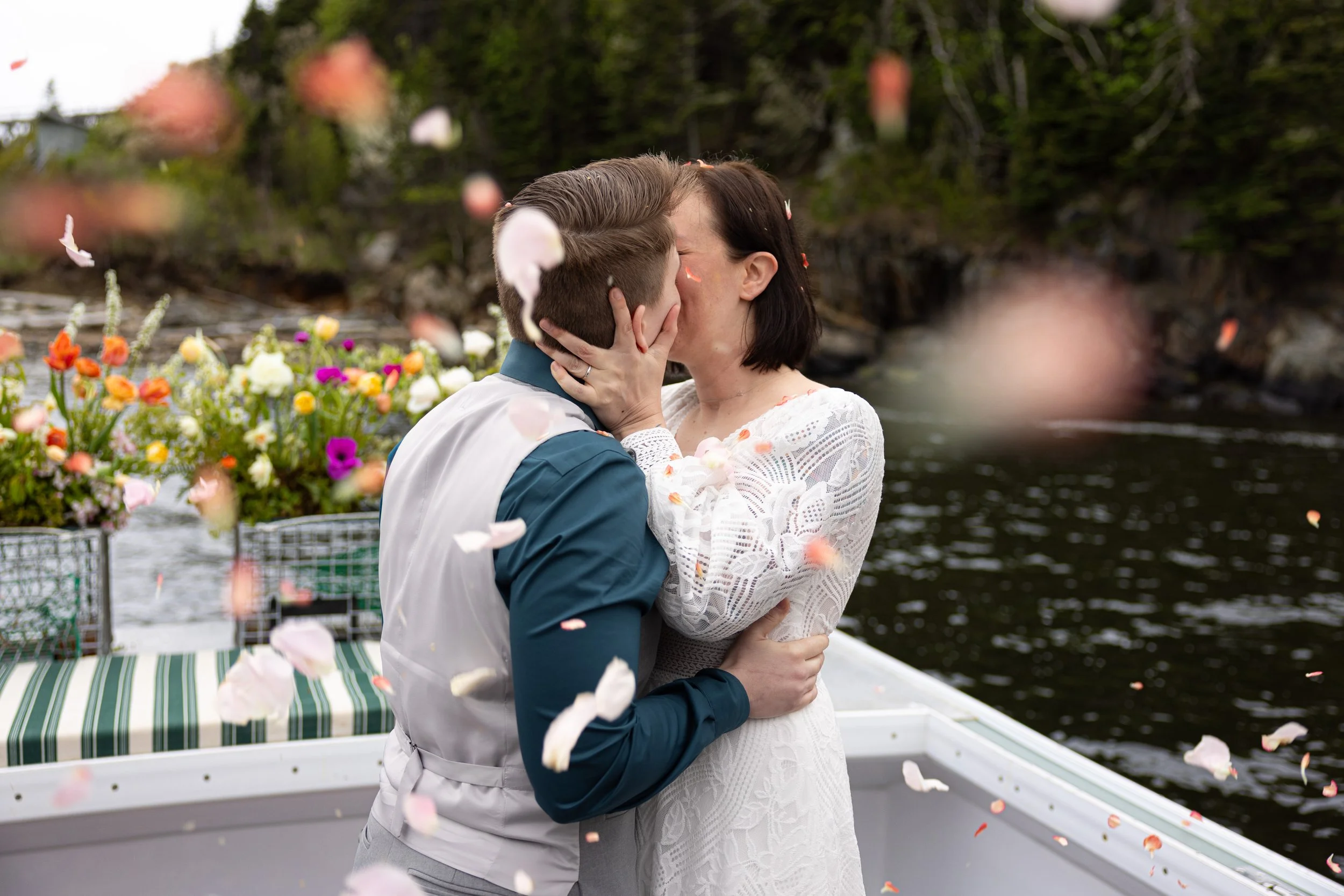 couple eloping on rocky coast of Seguin Island Maine on cloudy day