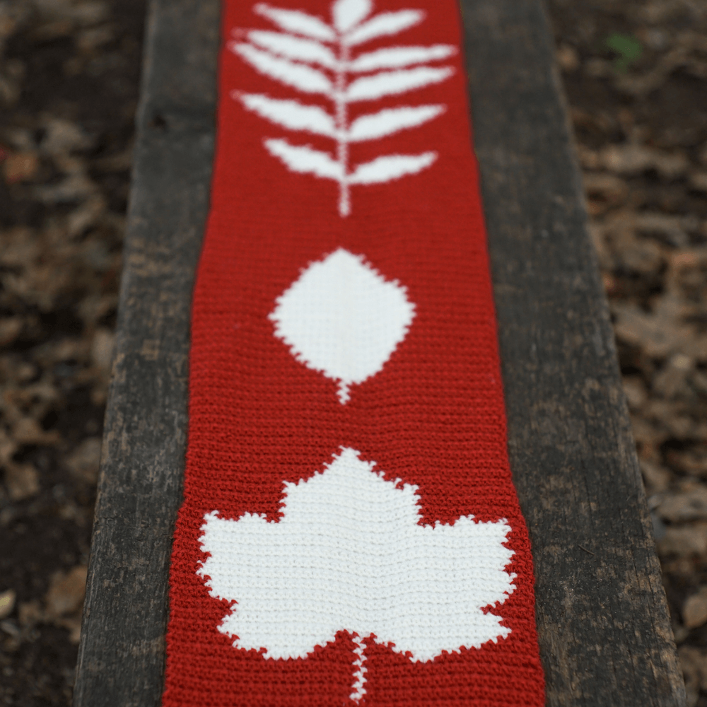 crocheted british leaves autumnal scarf lying on a bench square tiny.png
