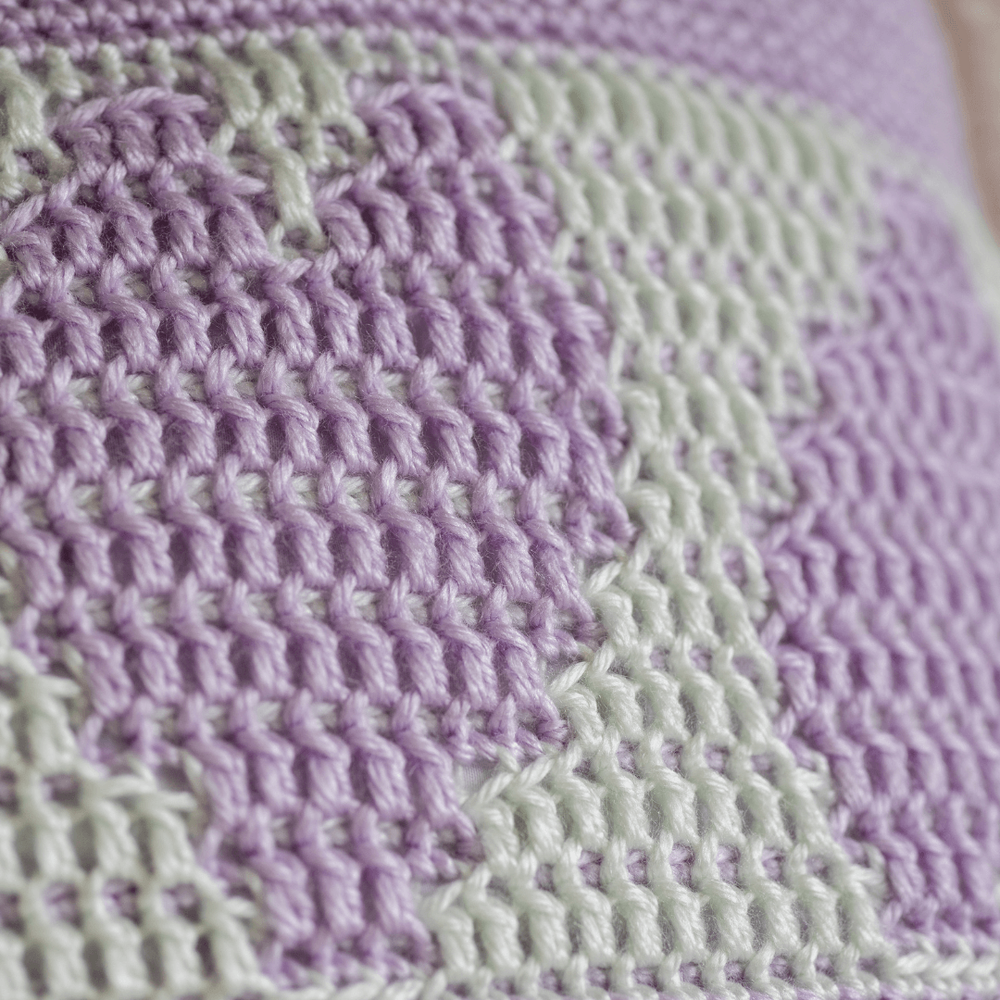 close up of a heart on the crocheted simply love mosaic cushion cover in lavender and pale green tiny.png