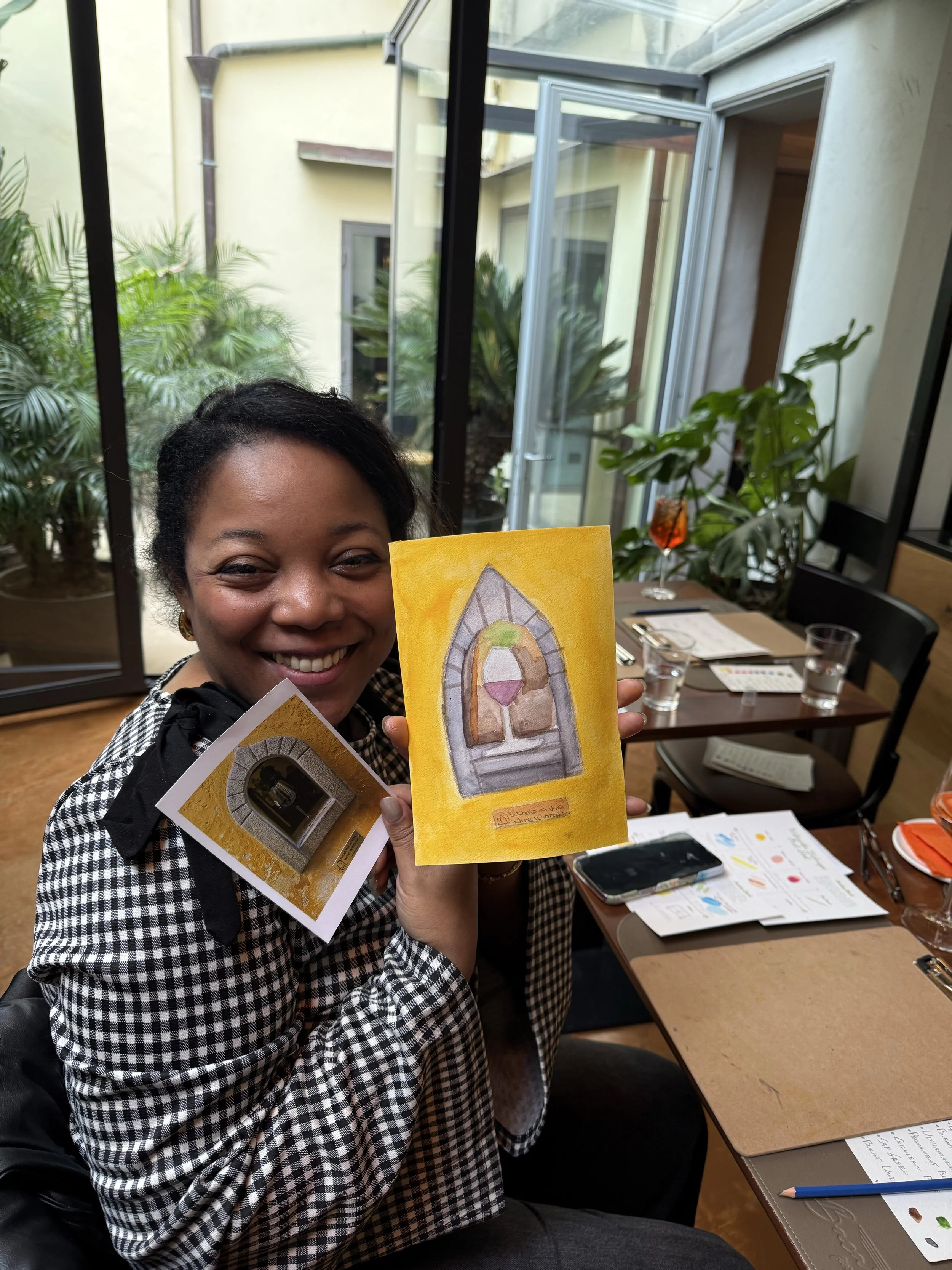 The social atmosphere of a private watercolor class in Florence Italy, featuring guests sketching and sipping cocktails in an elegant restaurant.