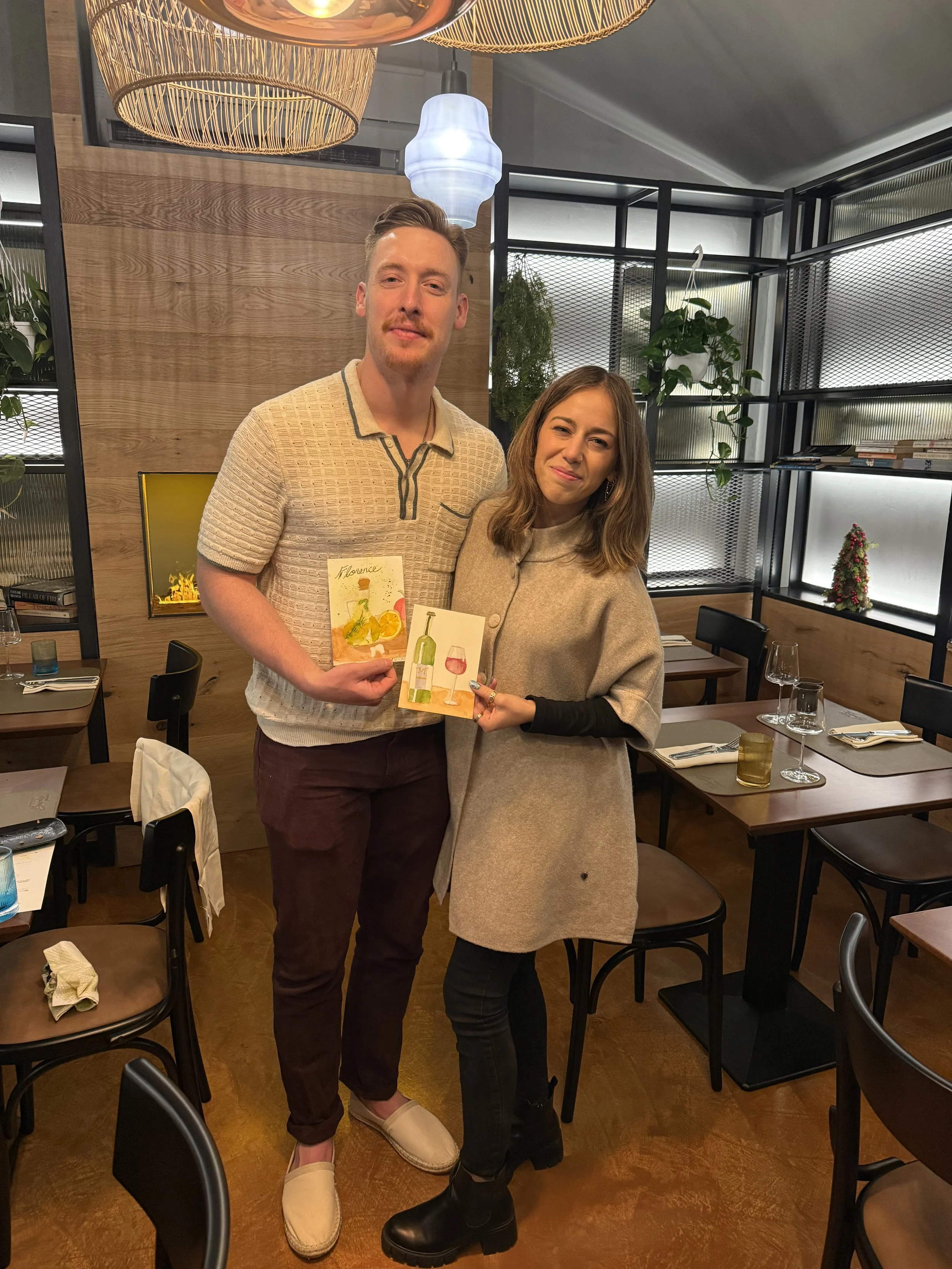 Artistic social event in Florence: guests painting Tuscan oil with a glass of wine