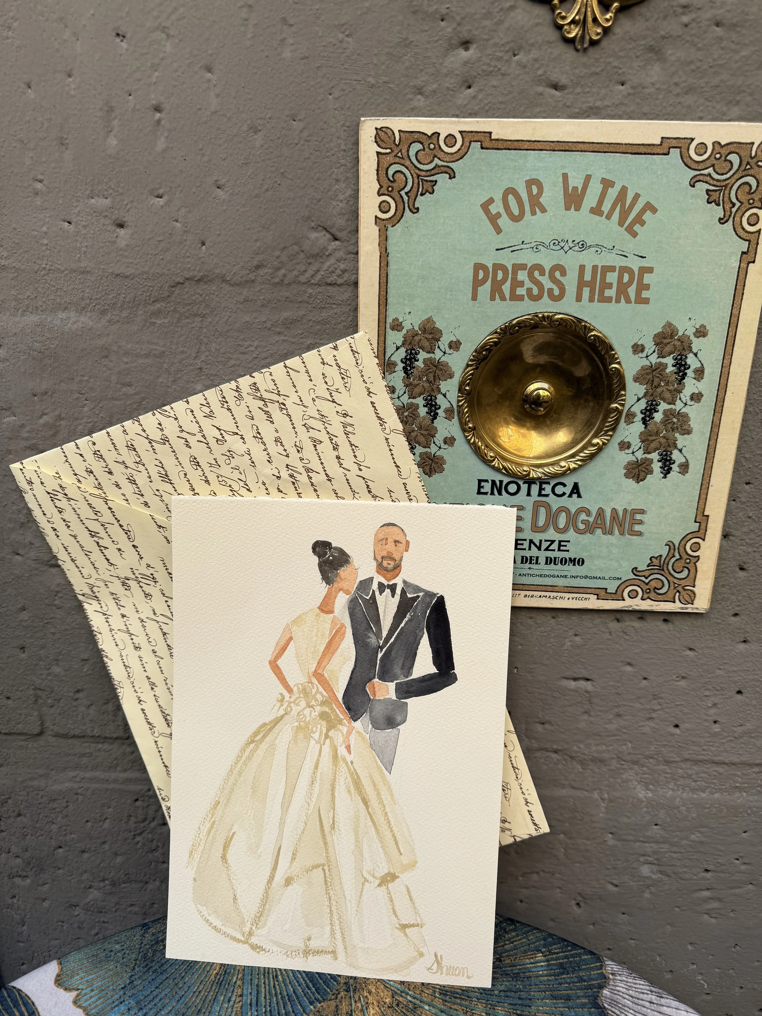 Live Italy wedding favor watercolor painting depicts a bride and groom in formal wedding attire, with the bride in a flowing gown and the groom in a tuxedo, standing side by side.