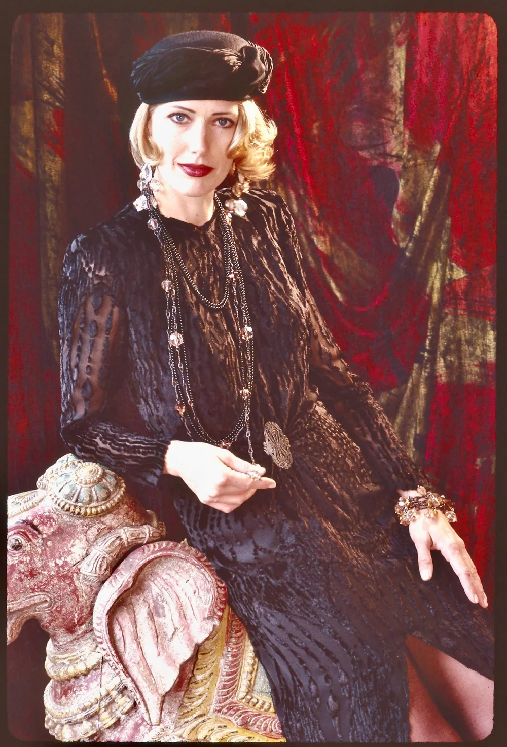 A model wears a black jacquard-woven silk velvet dress, part of Marian's "Classics" collection from the 90s
