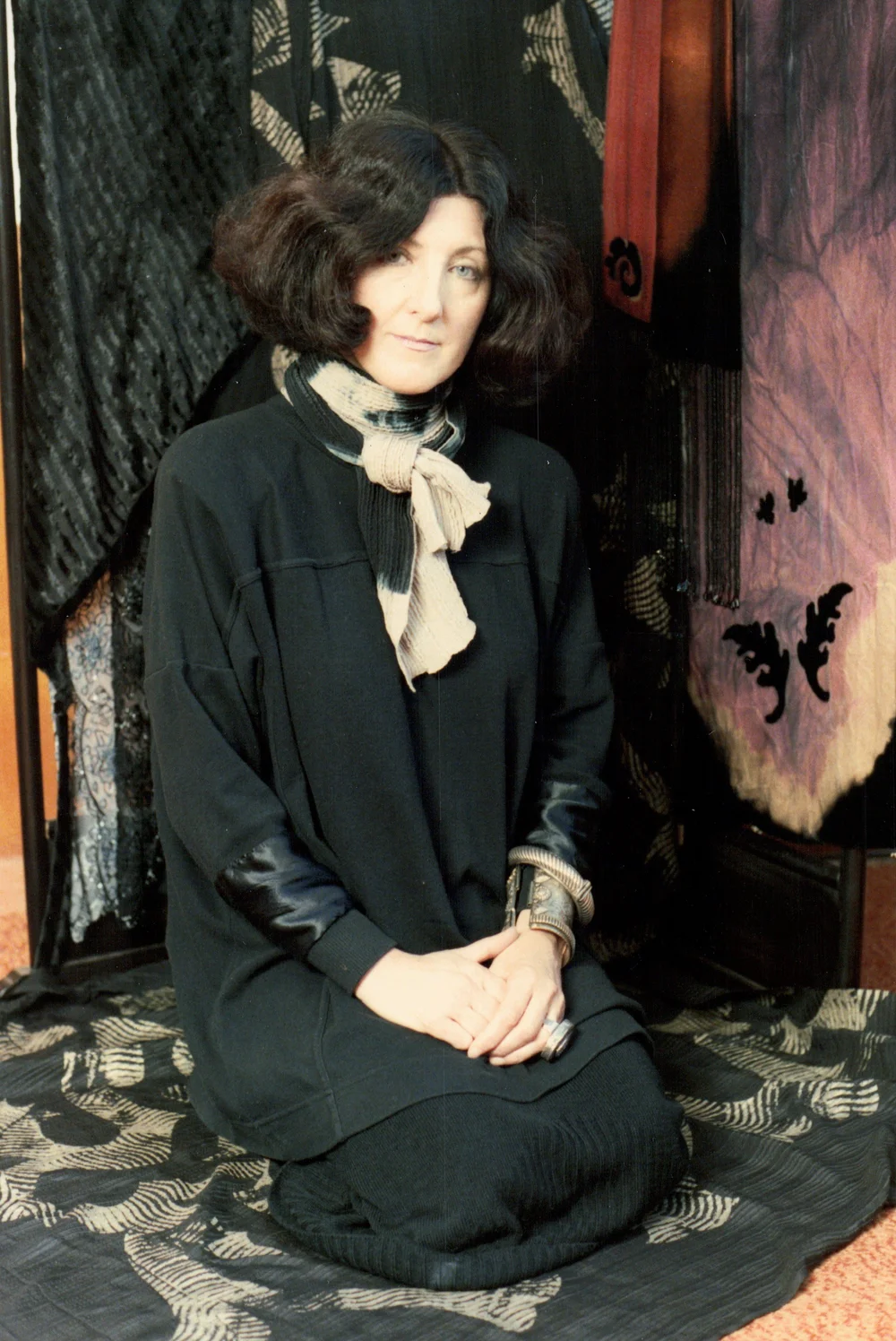 Marian posing with some of her fabrics 