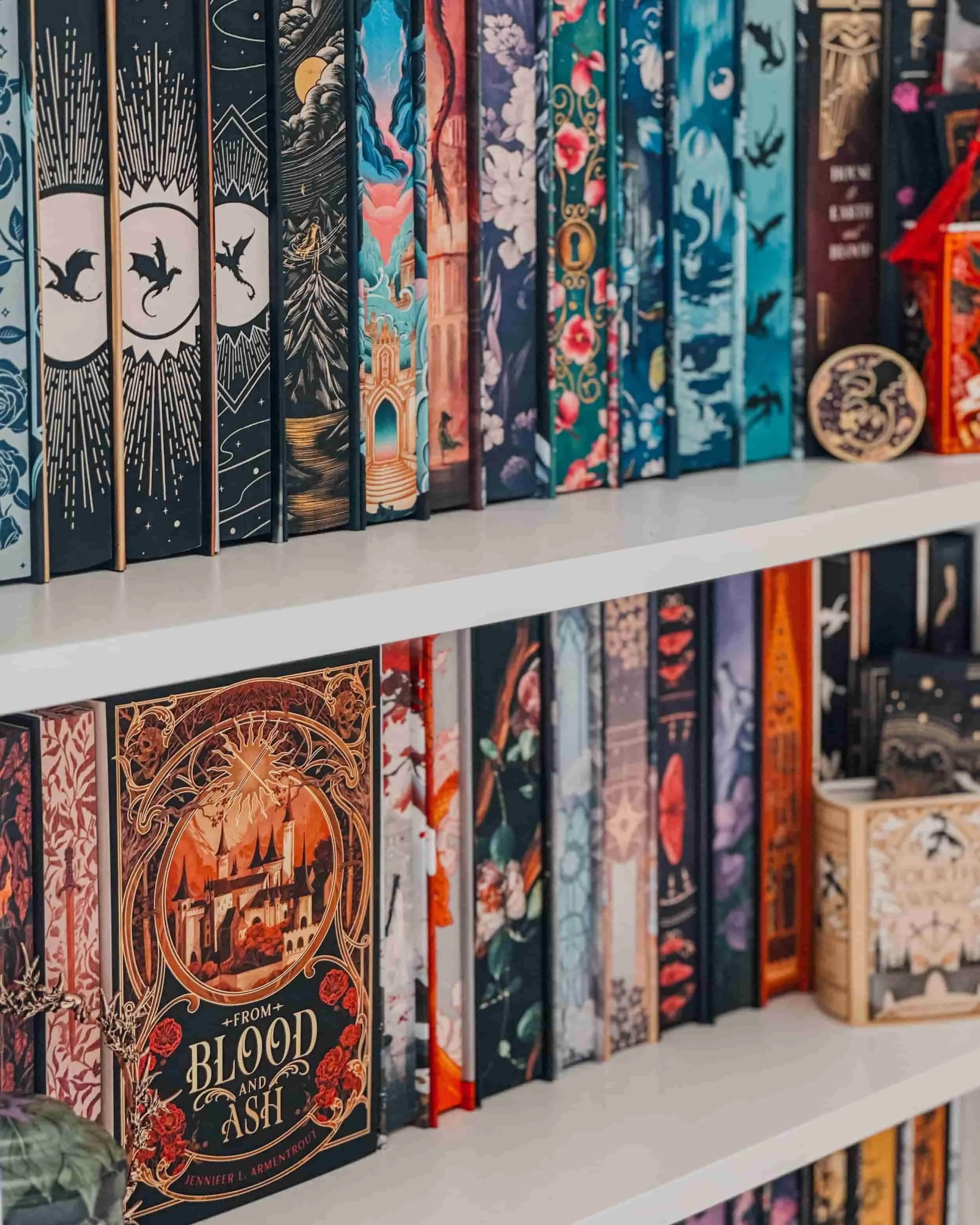 A photo showing selves of special edition fantasy books with sprayed edges.