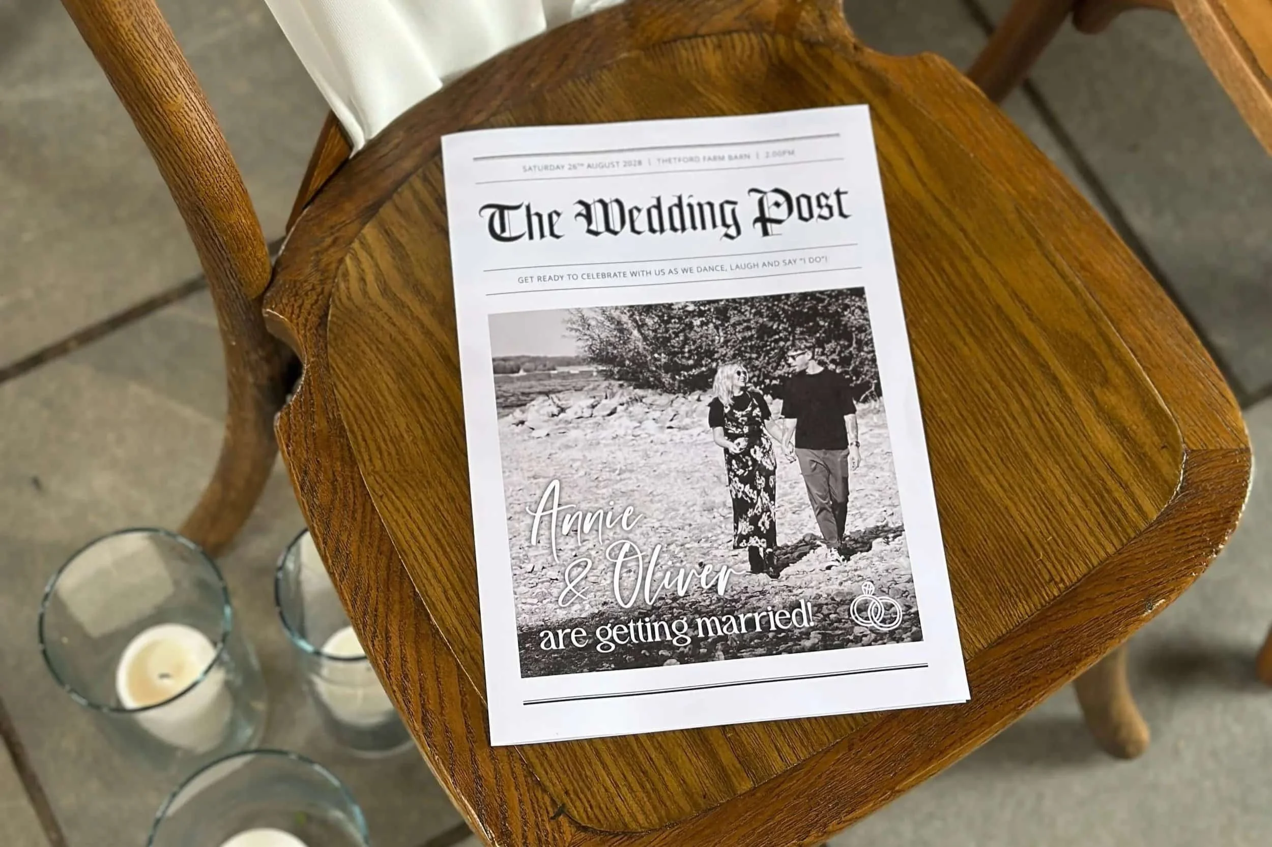 The front of a black and white wedding newspaper on a ceremony chair.