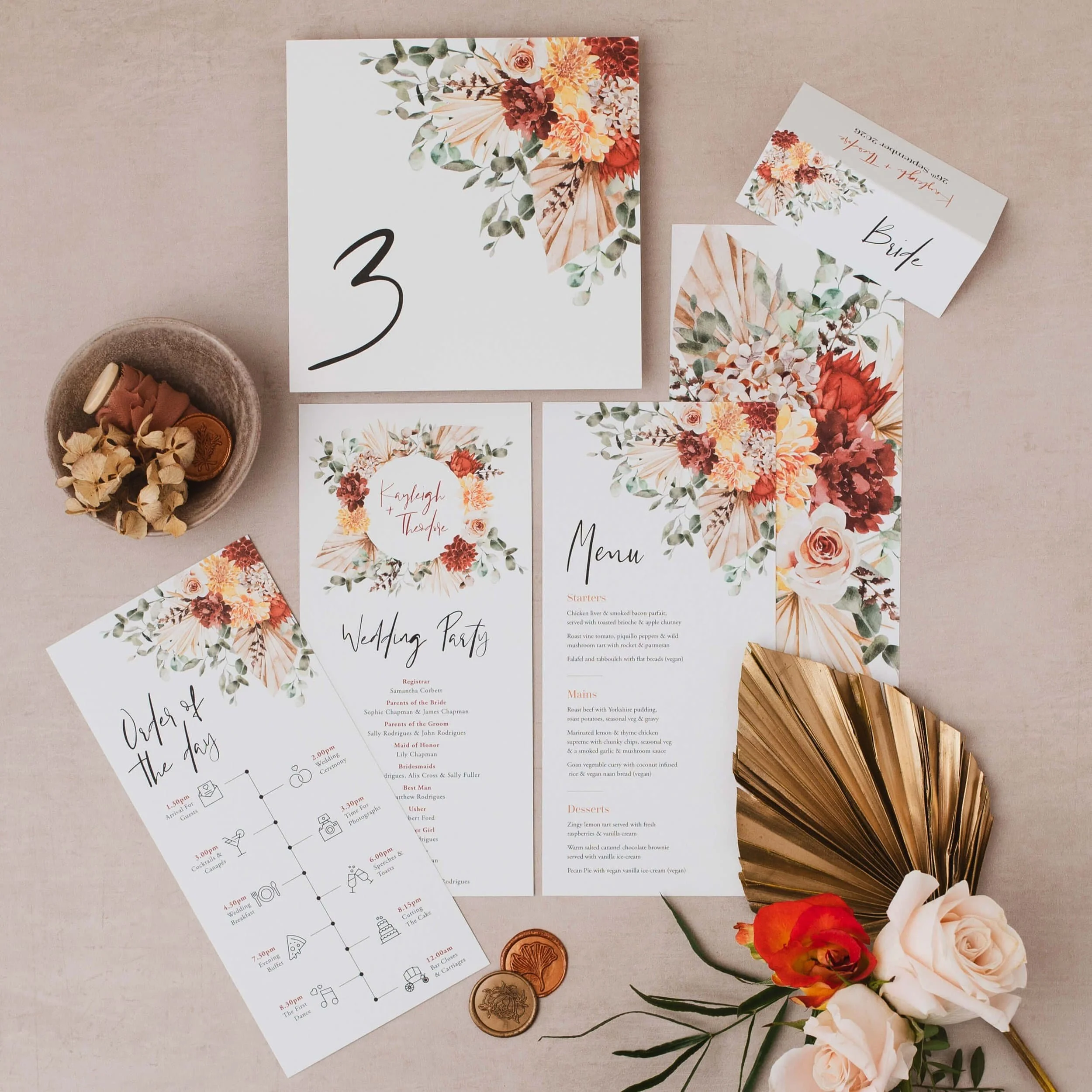 Autumnal floral on the day wedding stationery including an order of the day timeline, menu, place card and table number.