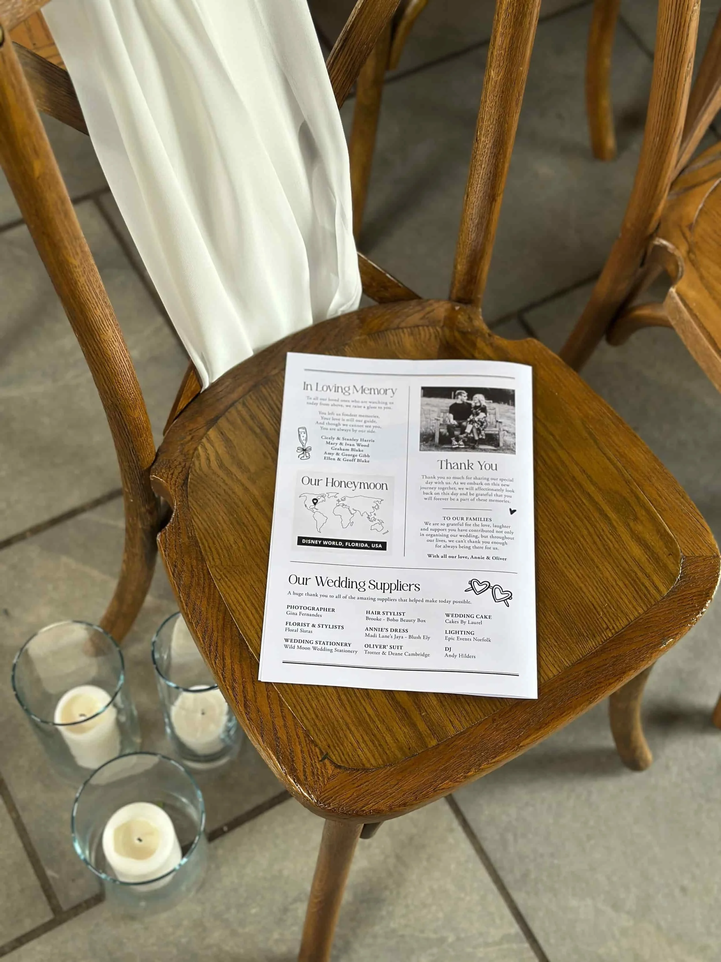 The back of a black and white wedding newspaper on a ceremony chair.