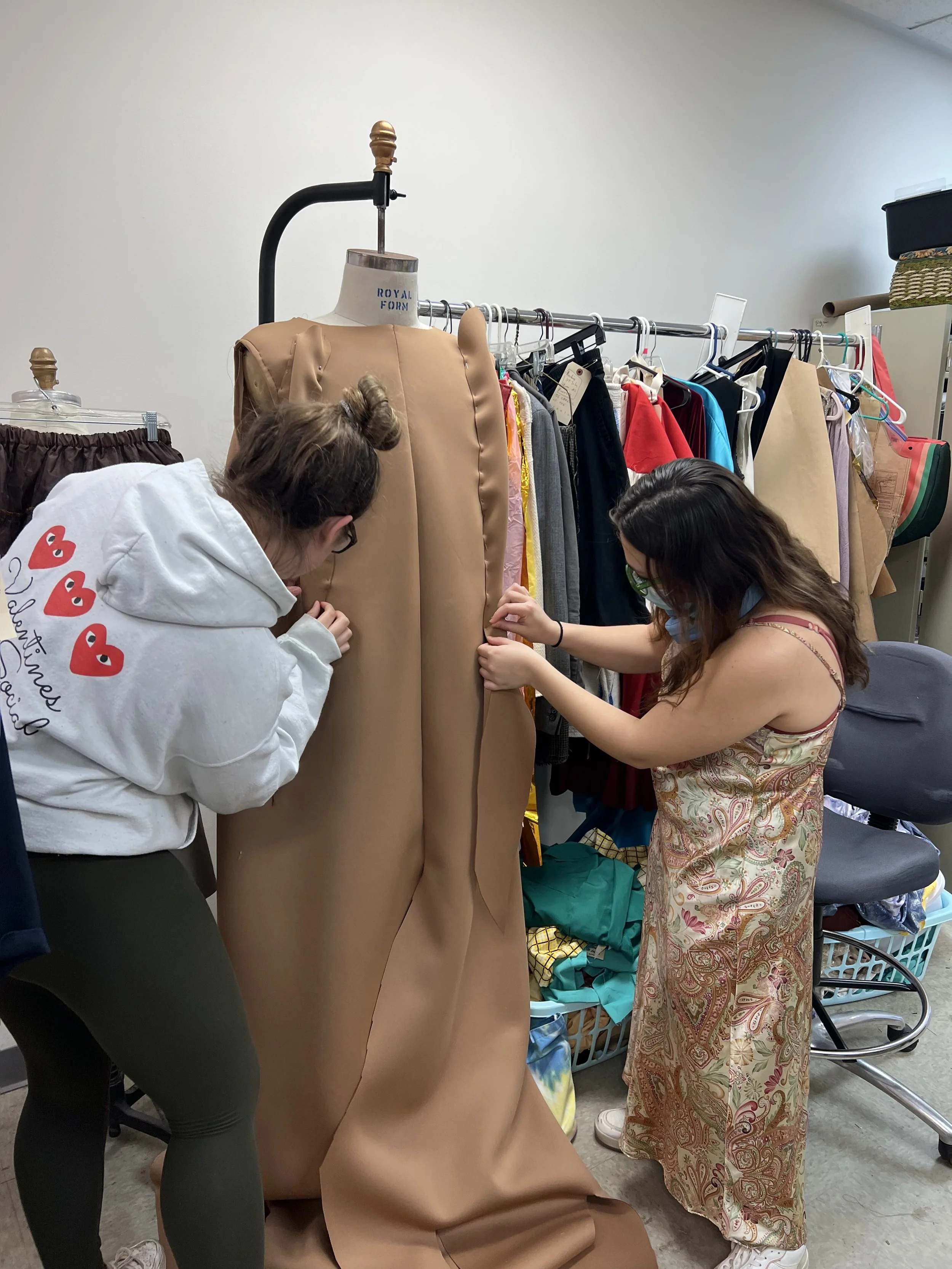 This is me (on the right) showing my lead artisan Leigh Engels the draping technique I accomplished so she could continue the project while I focused on other puppets.