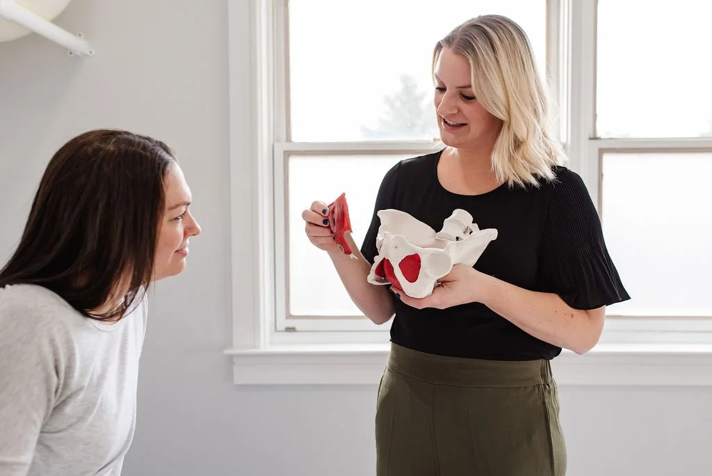 A pelvic floor therapist instructing a patient with perimenopause on pelvic floor exercises for perimenopause