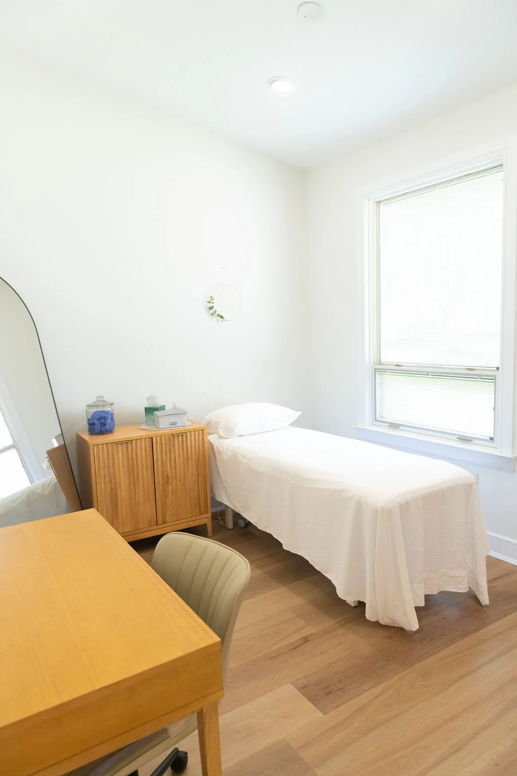 A photo of our pelvic floor therapy office in Doylestown, PA, consisting of a treatment table and a desk for pelvic floor treatment.