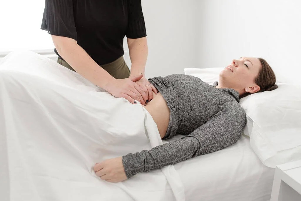 A pelvic floor physical therapist performing visceral mobilizations on a patient in pelvic floor therapy in Newtown, PA