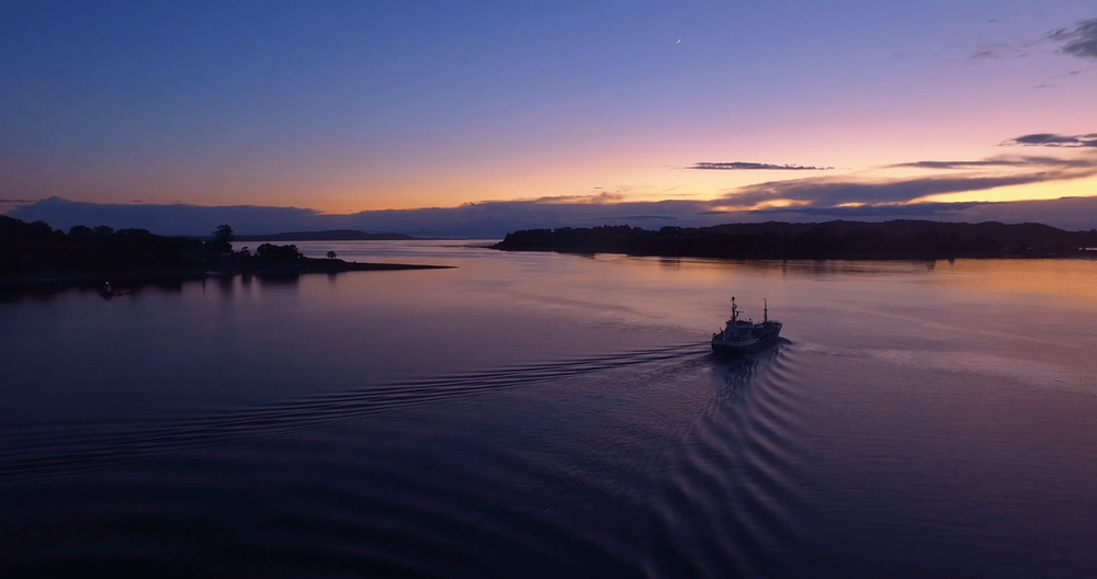 videoblocks-low-altitude-aerial-view-of-ship-sailing-in-the-chiloe-archipelago-before-the-sun-rises-blue-hour_blxjtkuxl_thumbnail-1080_01-min.png