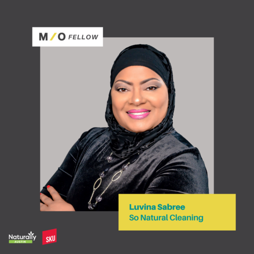 Portrait of Luvina Sabree smiling, wearing a black headscarf and velvet top, with a yellow label that reads "Luvina Sabree So Natural Cleaning."