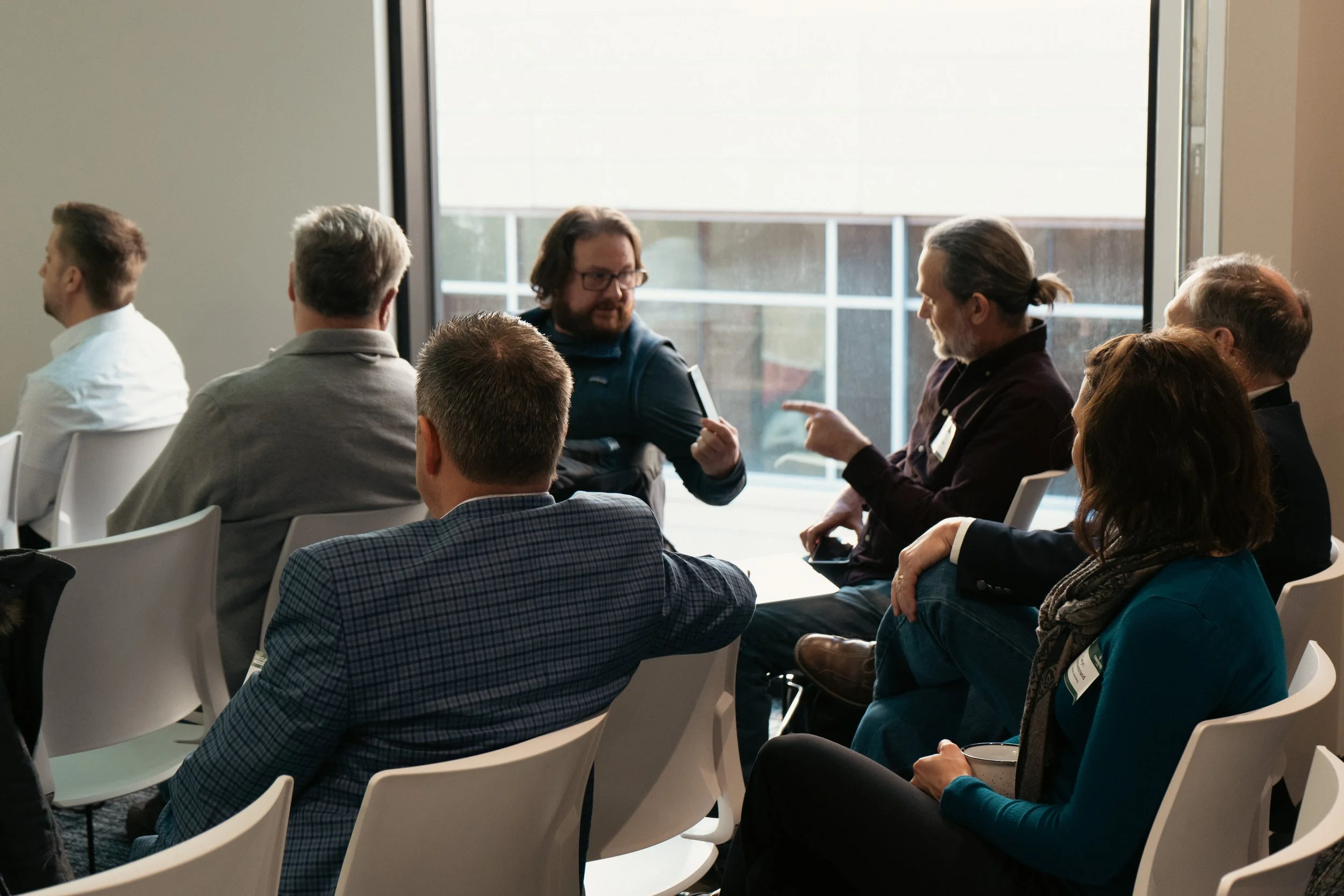 People sitting and talking to each other at a meeting