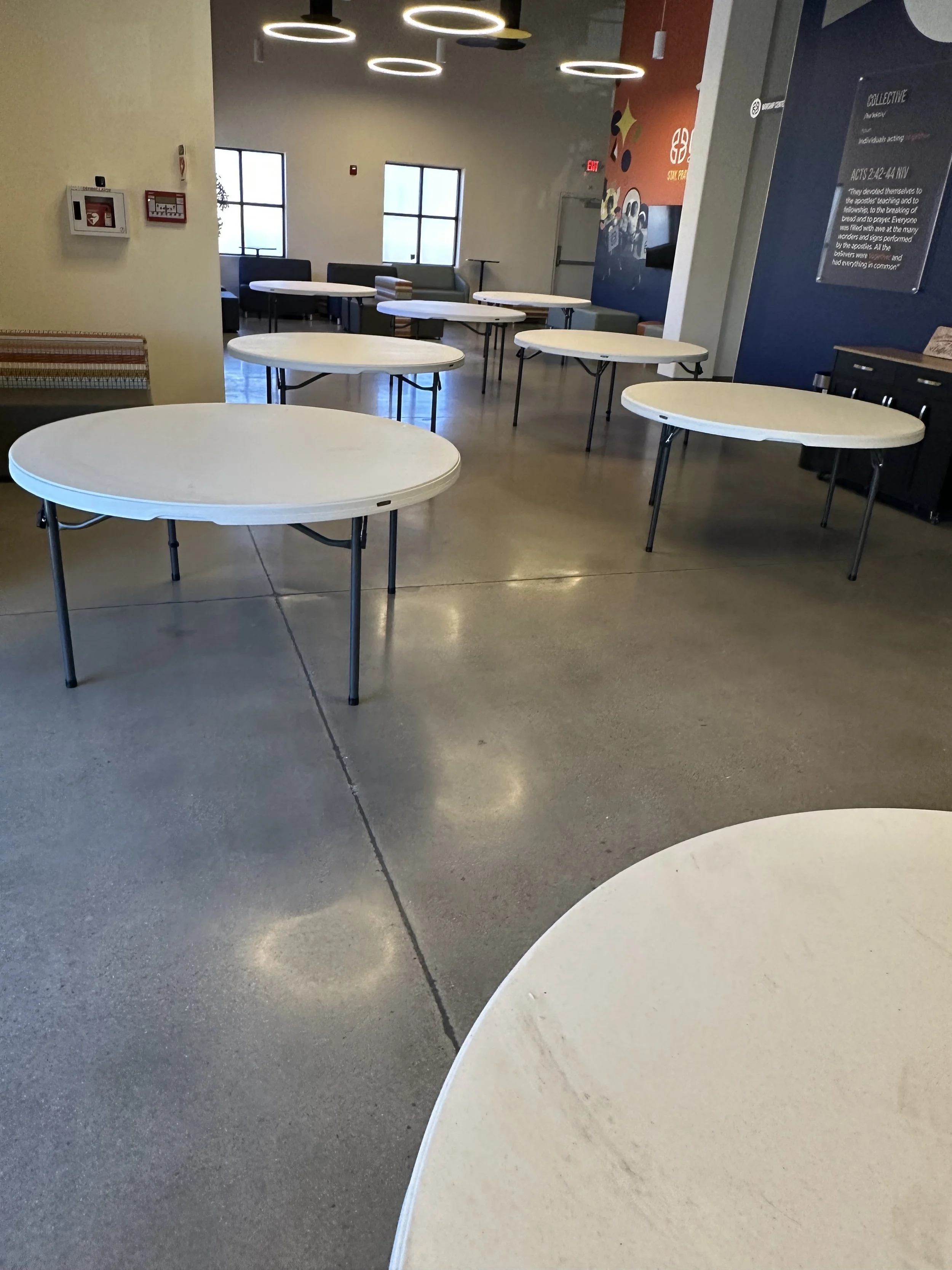 Room with round folding tables and modern lighting