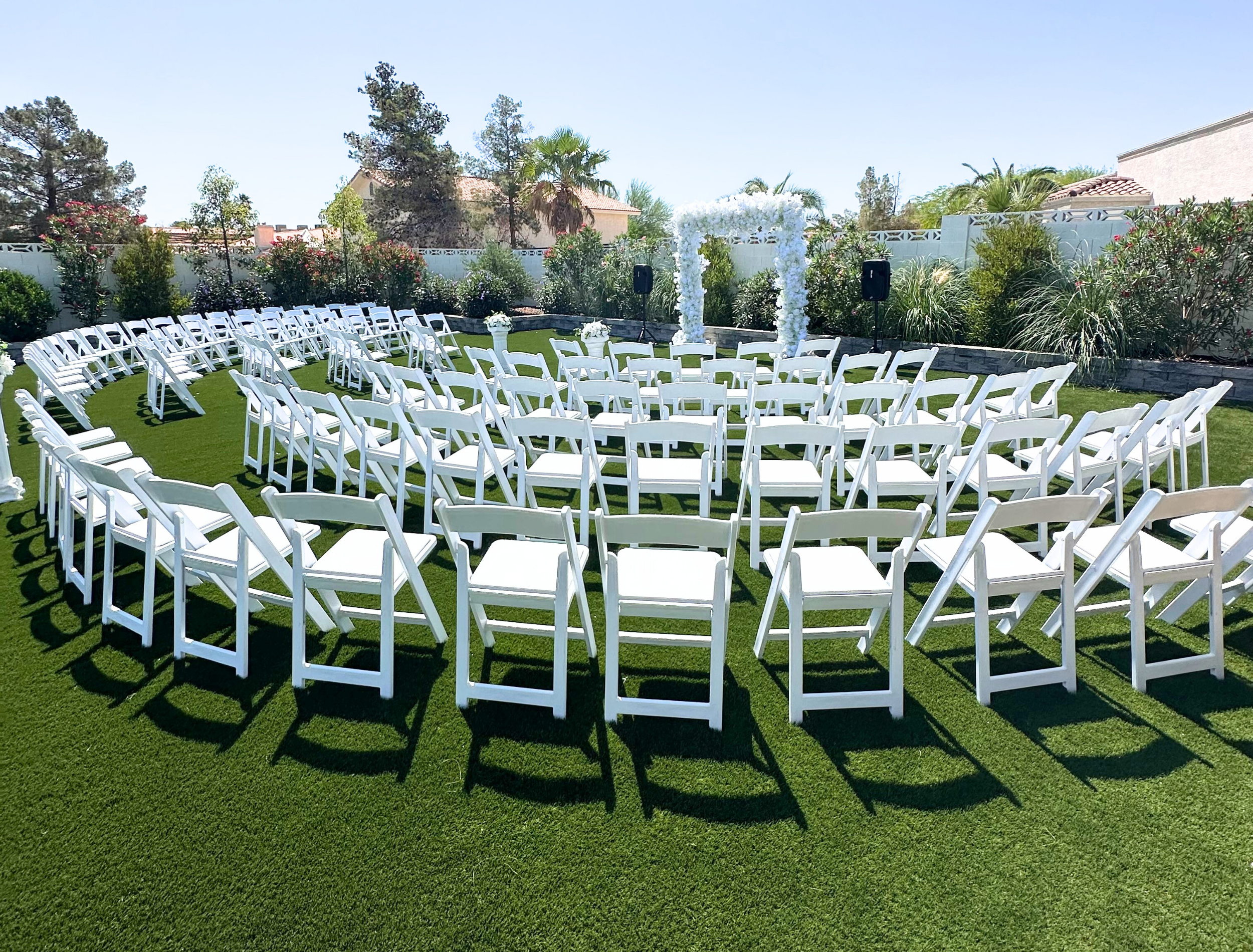 White padded resin folding chairs for wedding ceremony rentals