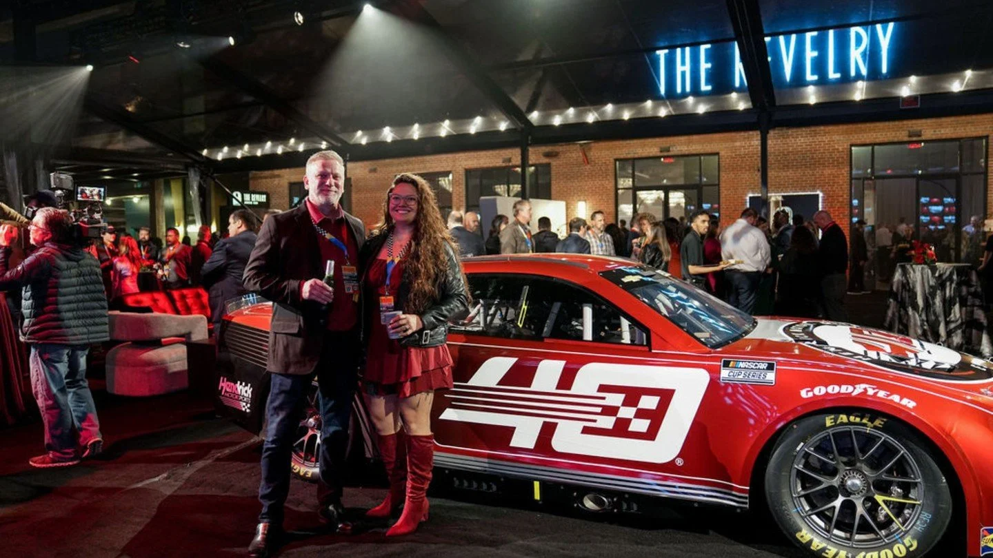 This outdoor tented reception was nothing short of impressive for the #TeamHendrick event. From the specialty bar with the customized ice sculpture to the 100-foot screen and the show-stopping 'car,' every detail was designed to honor four decades of