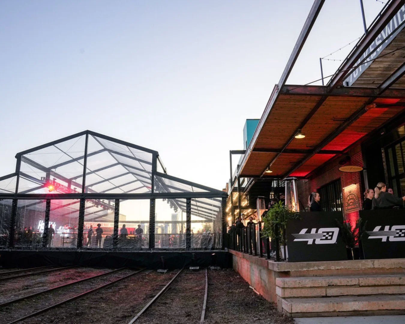 A look back at one of our most expansive setups to date. Seeing the historic @CampNorthEnd tracks transformed into a modern, high-energy experience is what we do best. From the clear-top tent spanning the tracks to the seamless indoor-outdoor flow, e