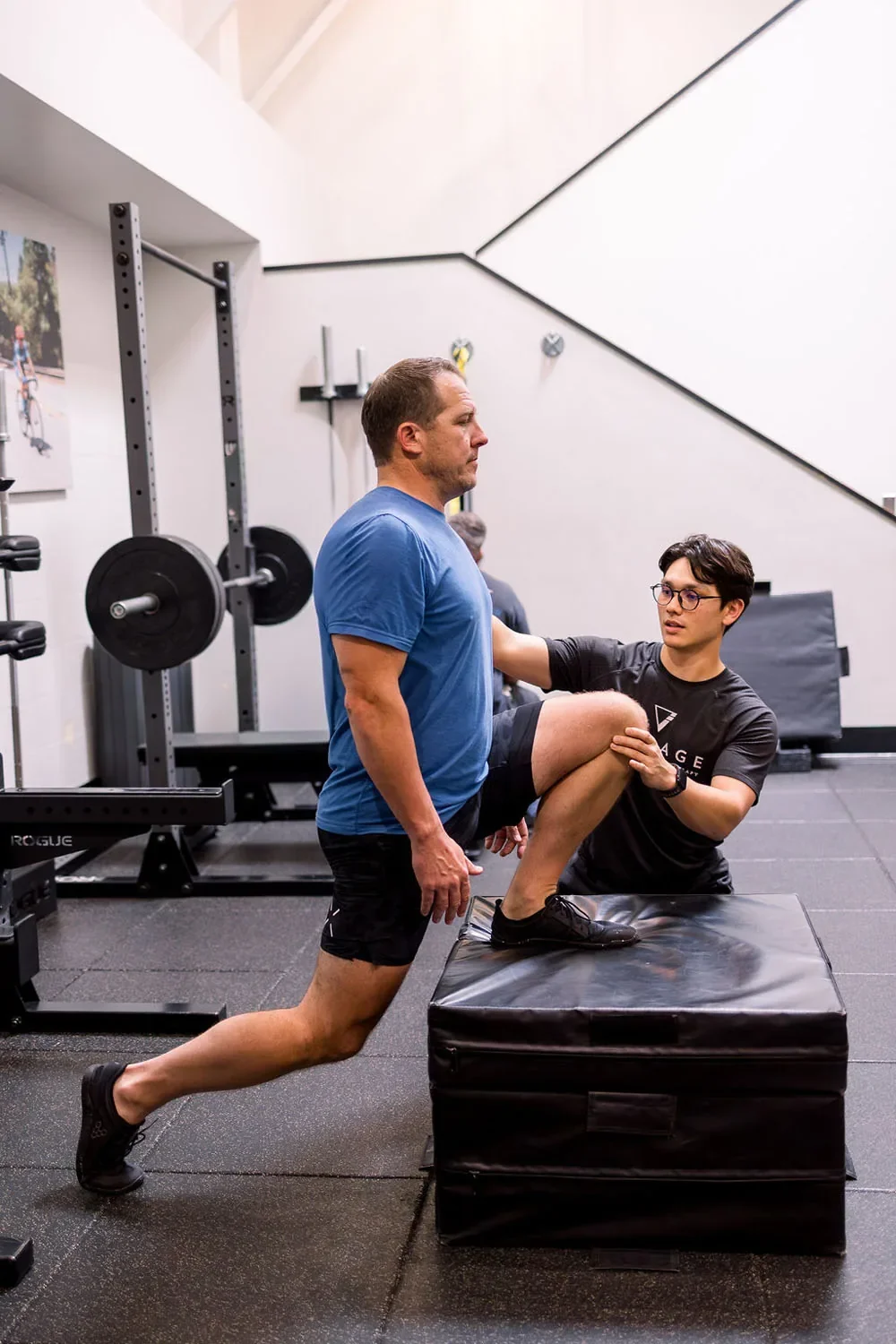 Village Fitness personal trainer cueing lunge depth and posture for a client during a one-to-one training assessment in San Marino