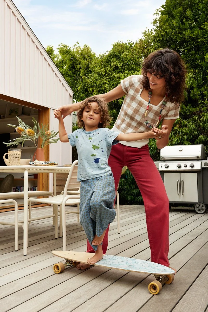 Candid lifestyle photography: mom teaching son to skateboard by Tara Donne, photographer & director working in NYC & LA