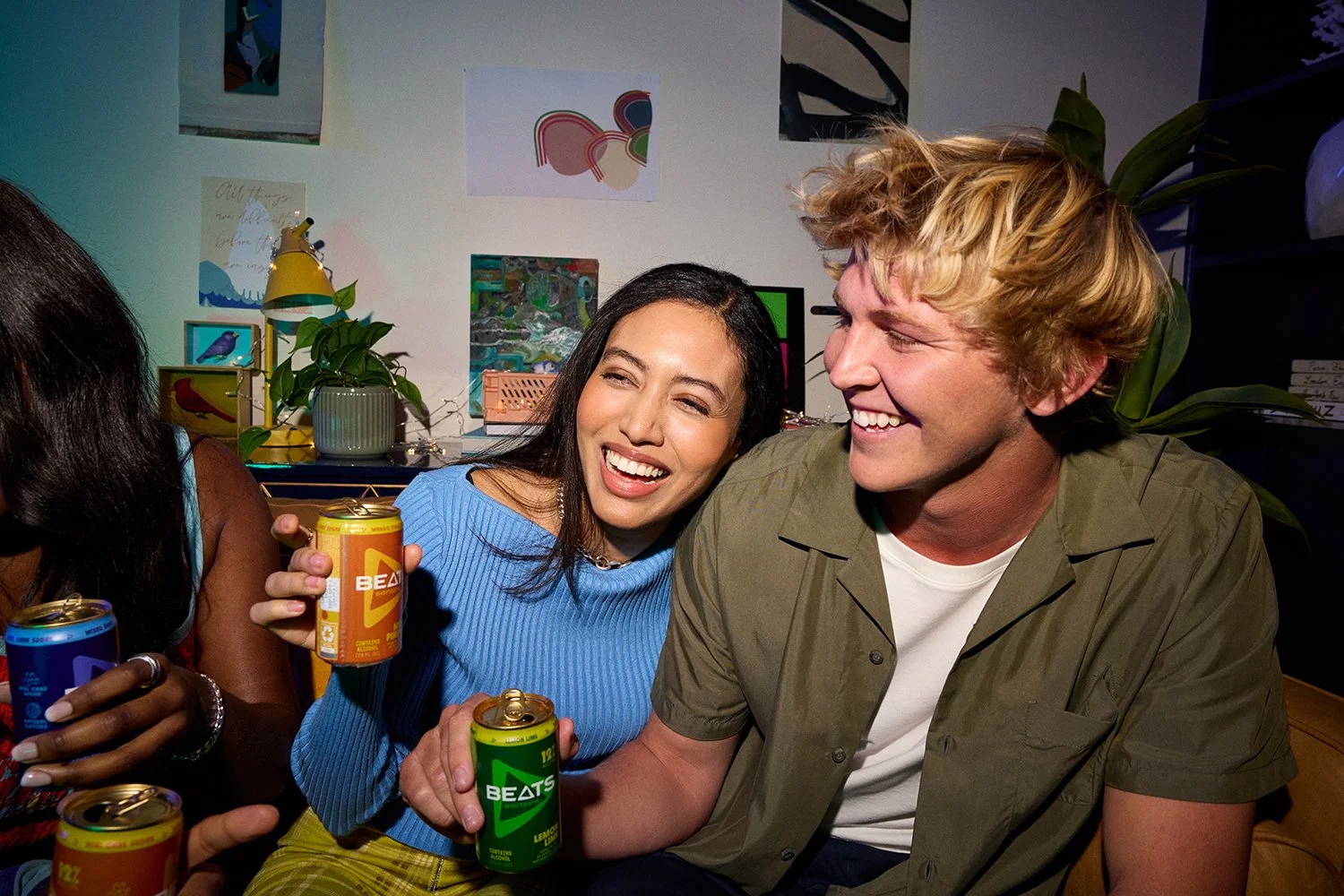 Candid lifestyle photography: friends laughing, drinking CPG on couch by Tara Donne, photographer & director working in NYC & LA