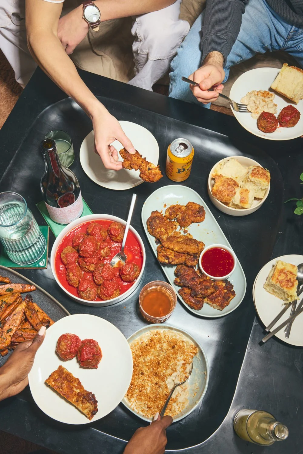 Candid food photography: friends eating comfort food by Tara Donne, photographer & director working in NYC & LA