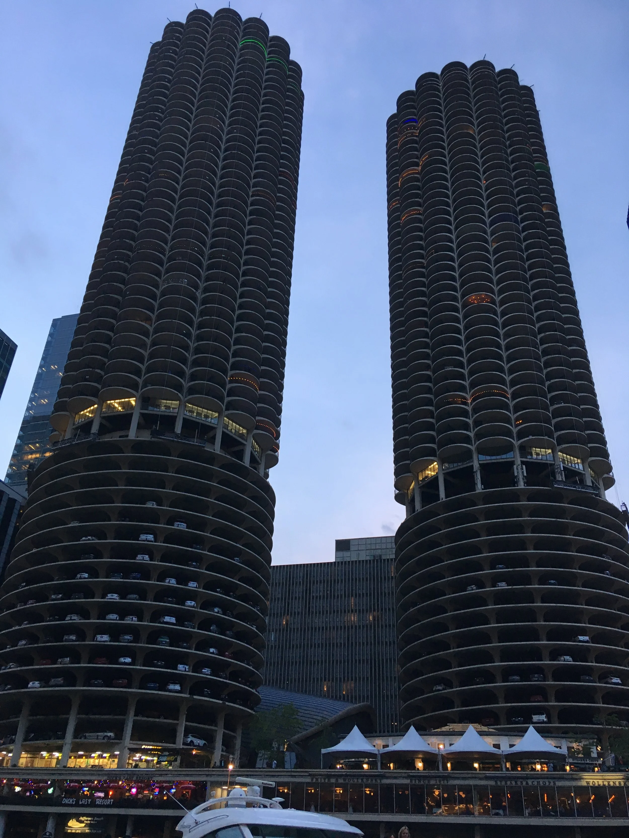 The Marina City towers, also known as the corn cob buildings, are two iconic cylindrical skyscrapers in Chicago with rounded balconies.
