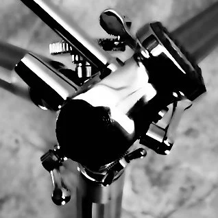 A workbench with a mounted robotic arm or machine tool, along with various tools and mechanical components.