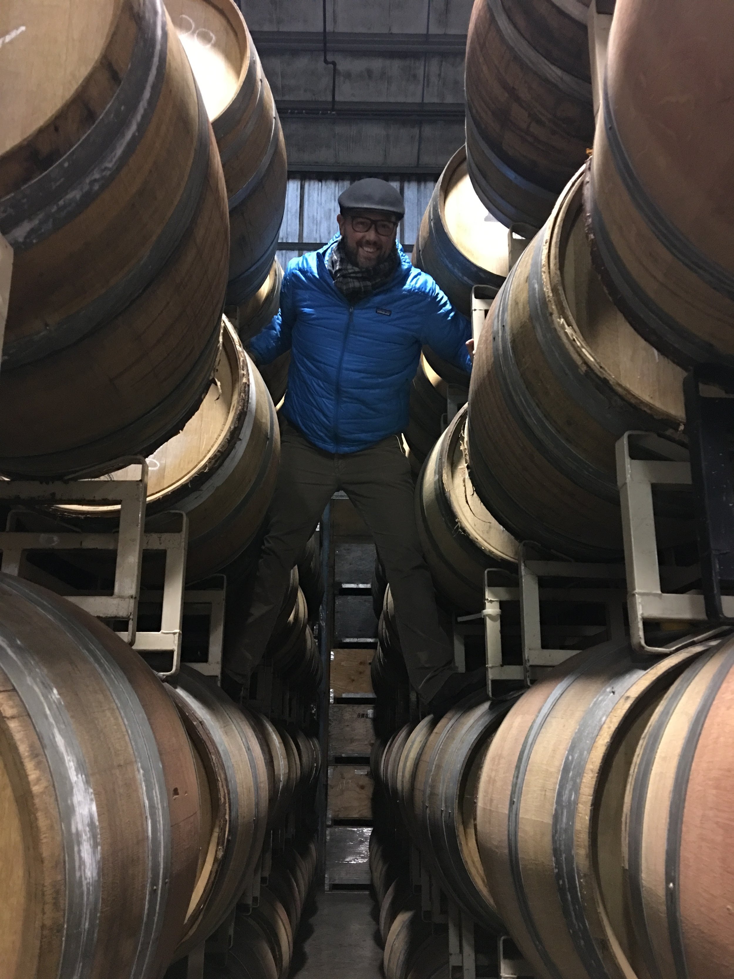 Winemaker in the barrel cave testing wine