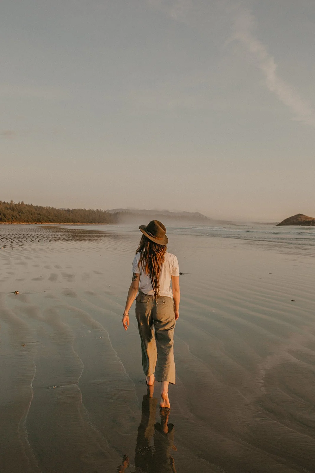 Woman on beach walking Vancouver island