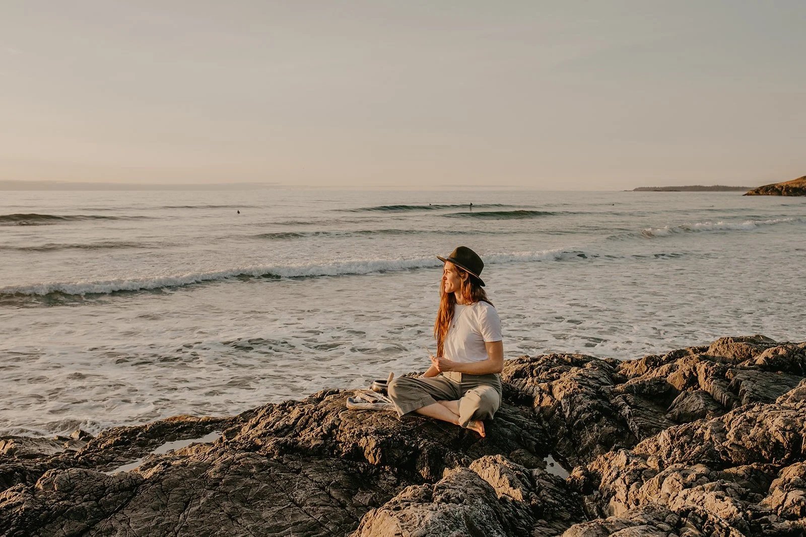Women on rock next to ocean