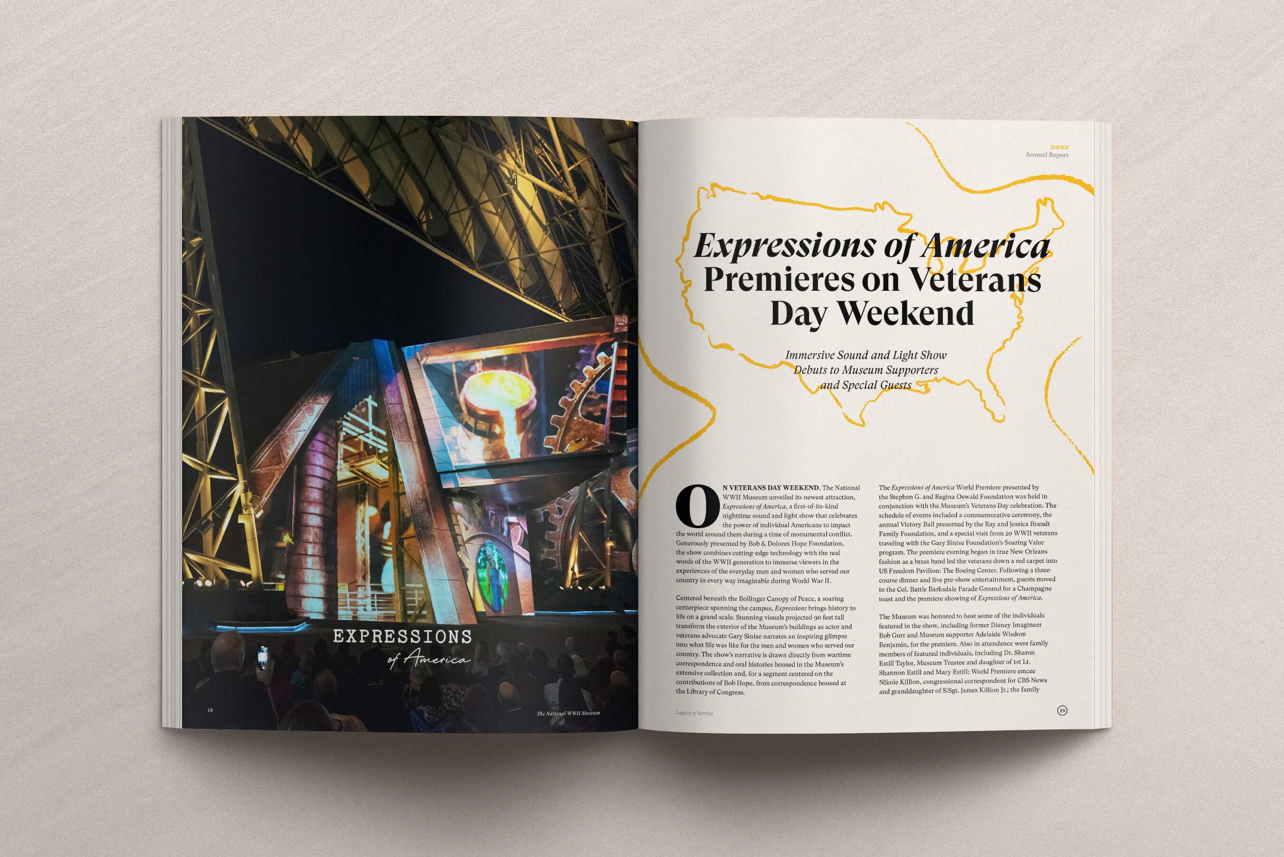  An open book spread featuring a vibrant photo of an illuminated structure on the left page, and a text article titled "expressions of america premieres on veterans day weekend" on the right page. 