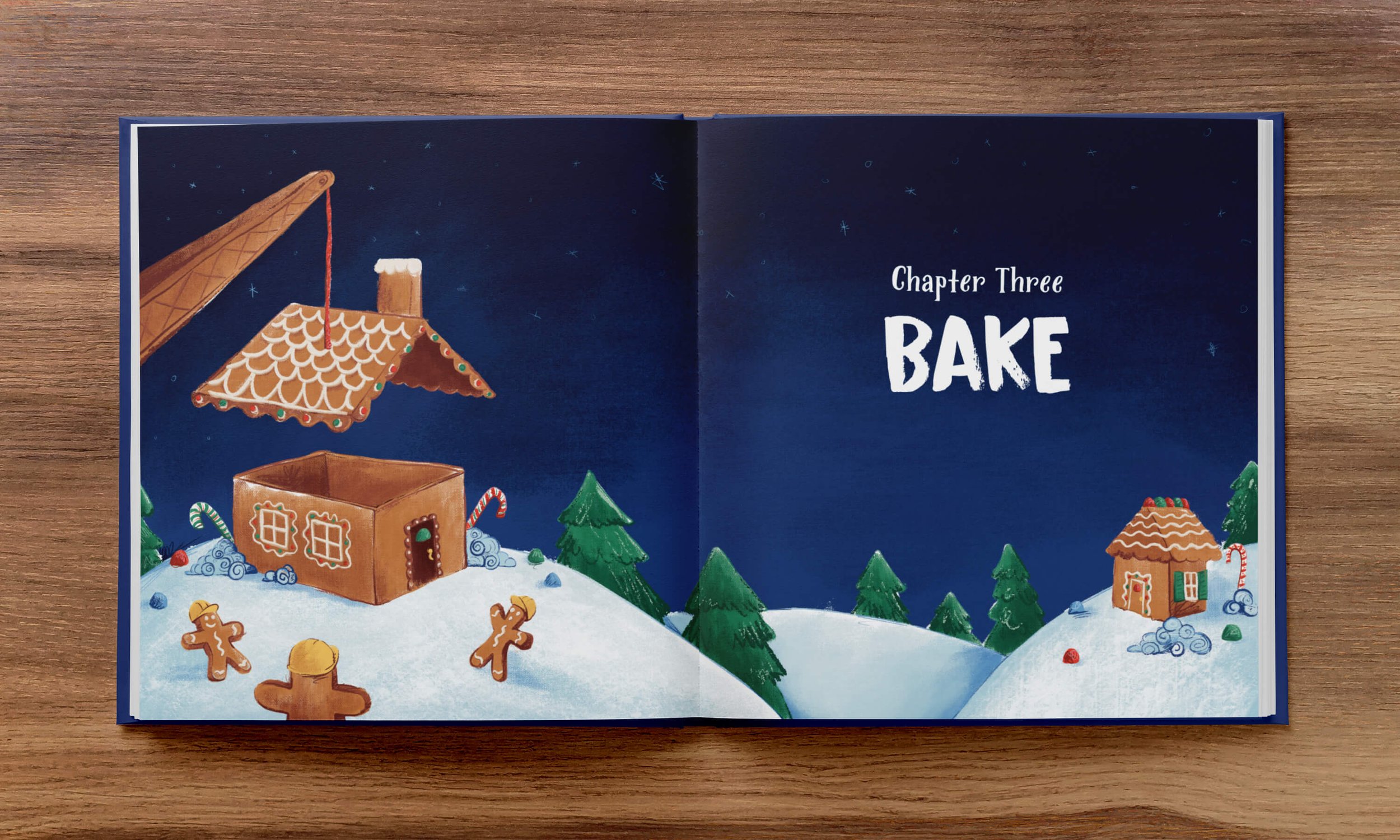  An open book with a colorful illustration of a snowy scene featuring a gingerbread house under construction by gingerbread men placing the roof on top of it with a red vine crane, titled "chapter three - bake”. 