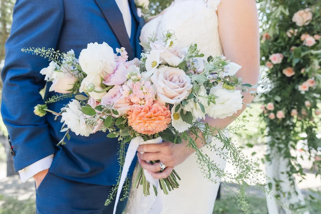 Bride and groom showing bridal bouquet