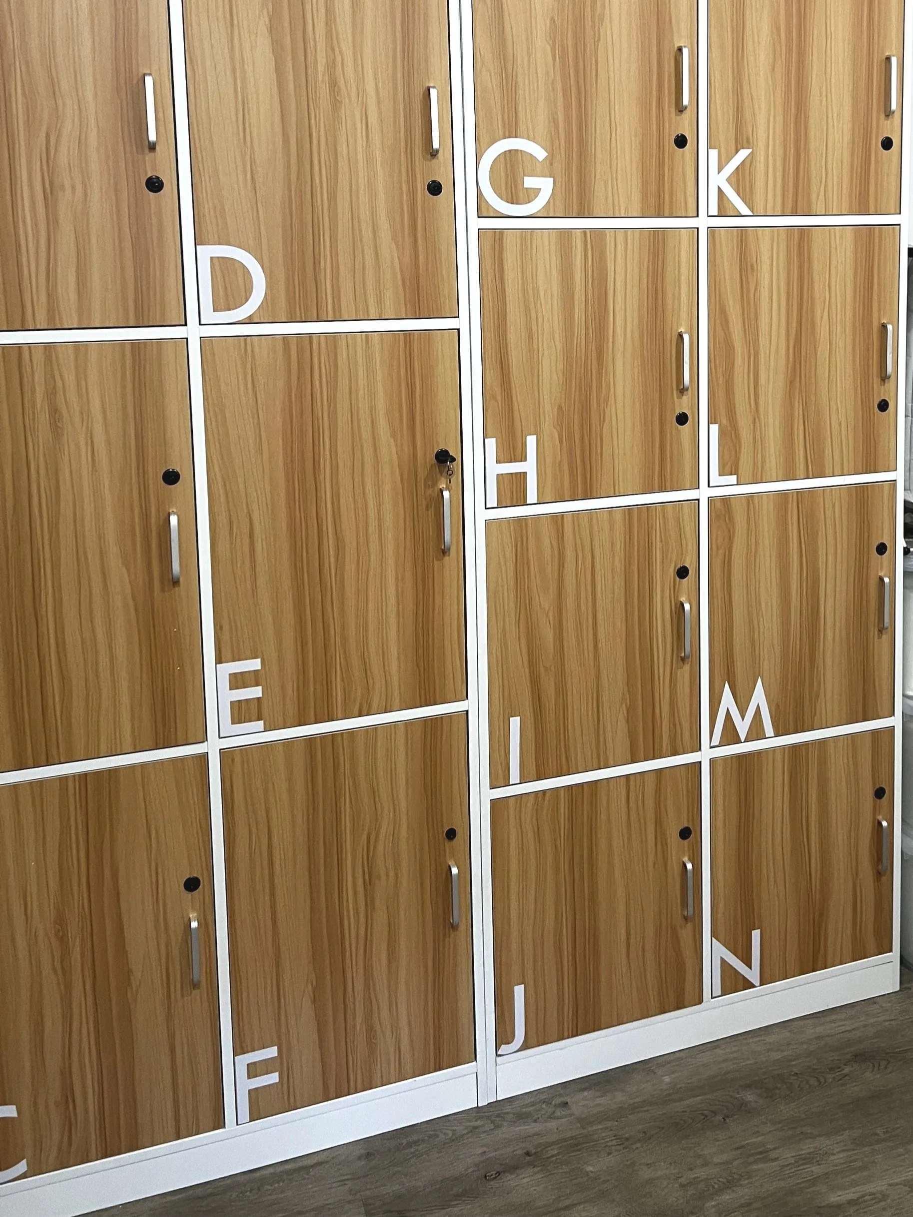 Wooden lockers with white letters and handles, some lockers have black locks.