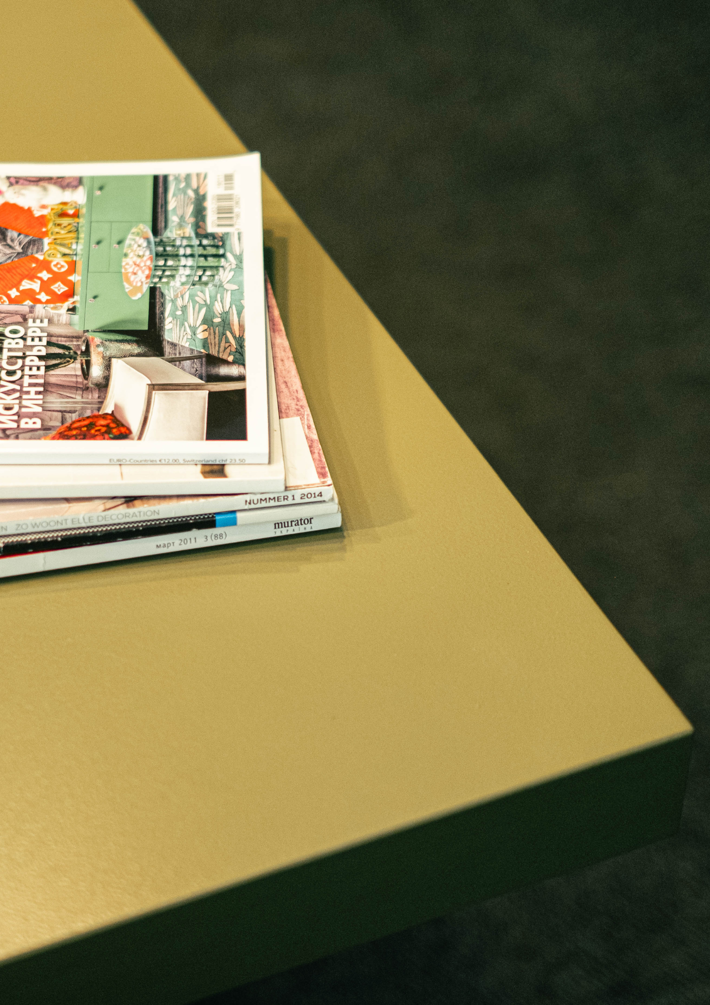A tall stack of magazines seen from the side, showing only their spines and page edges. Design Mood by ARDISENOSTUDIO