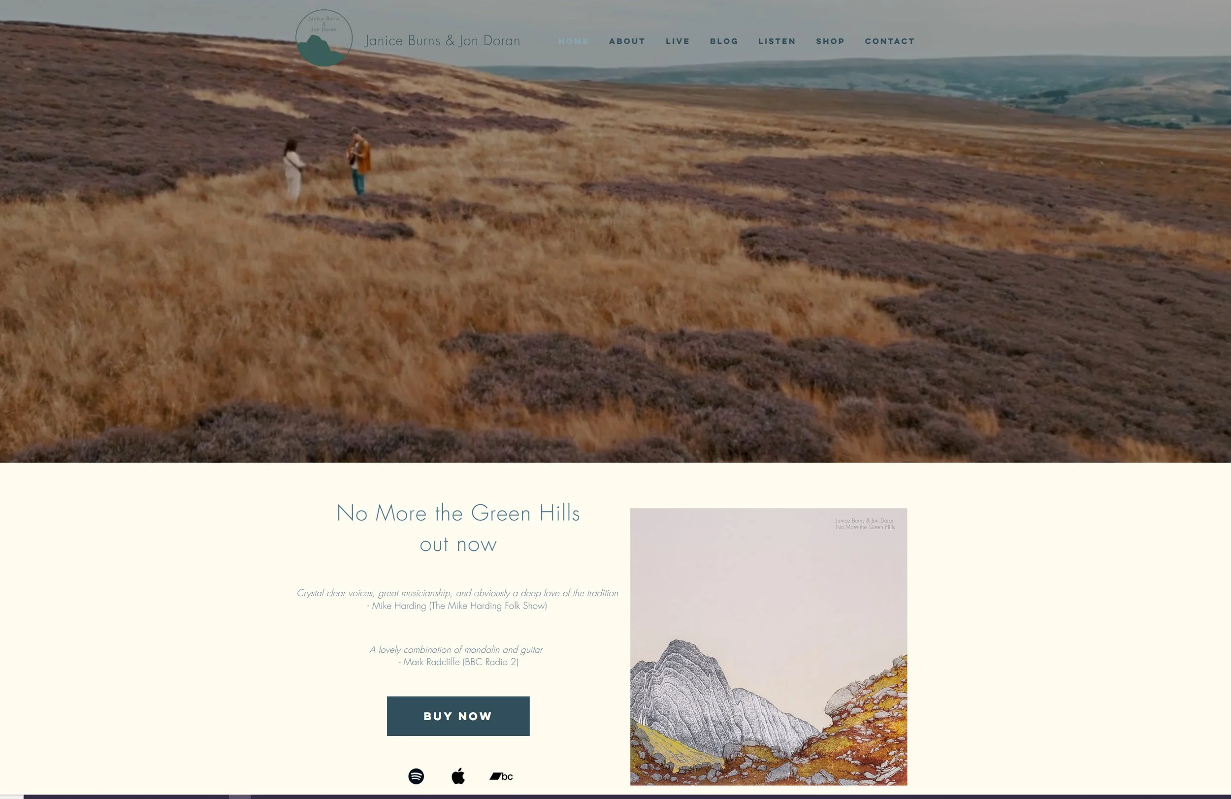 Webpage header with an image of two people walking in a hilly landscape with heather and grass fields, navigation menu, and an advertisement for music album "No More the Green Hills" featuring album art of mountain sketches and a "Buy Now" button.