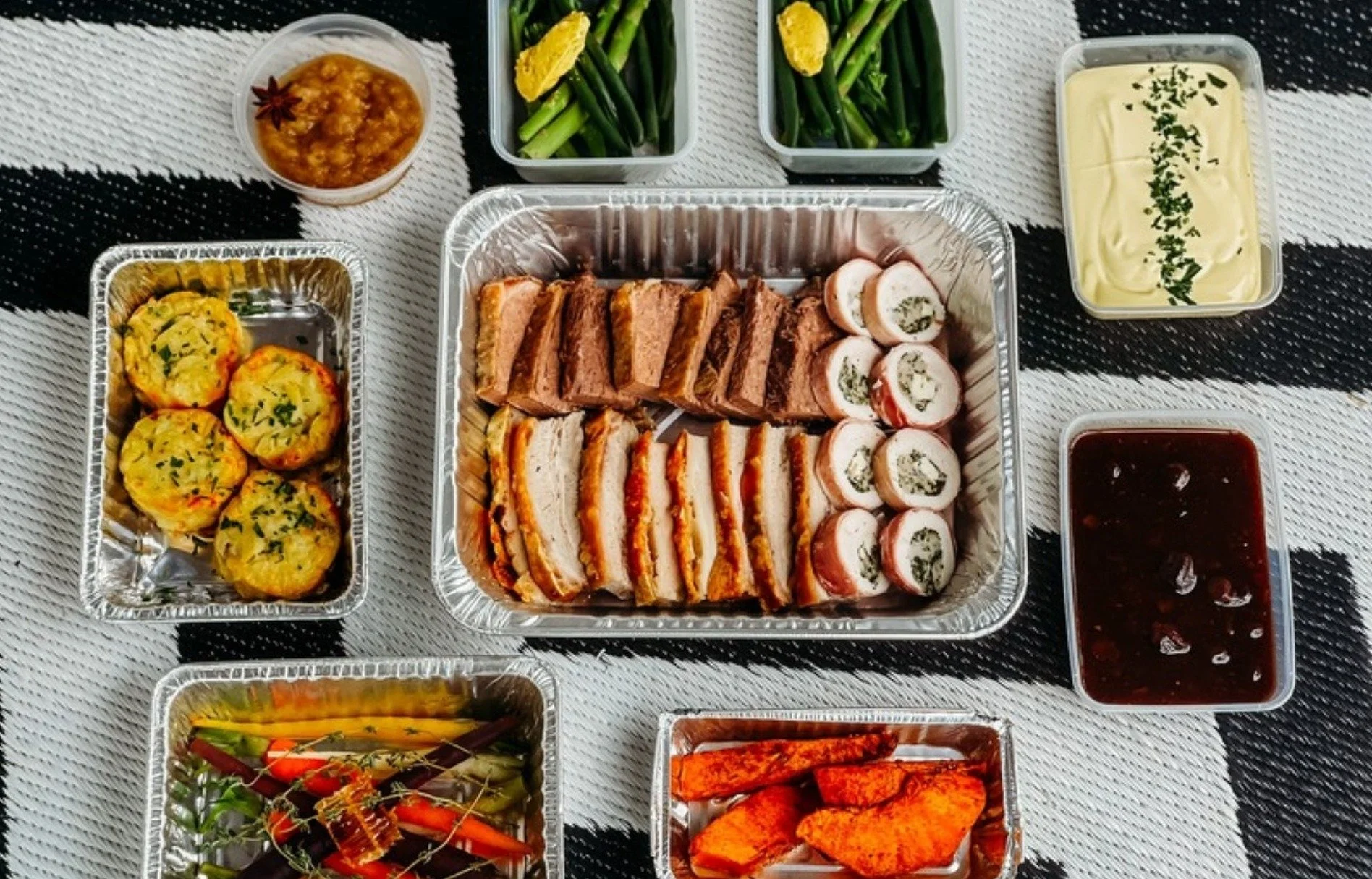 La Casetta Christmas Roast spread: sliced brisket, chicken Florentine, gratin, roast veg and sauces in takeaway trays