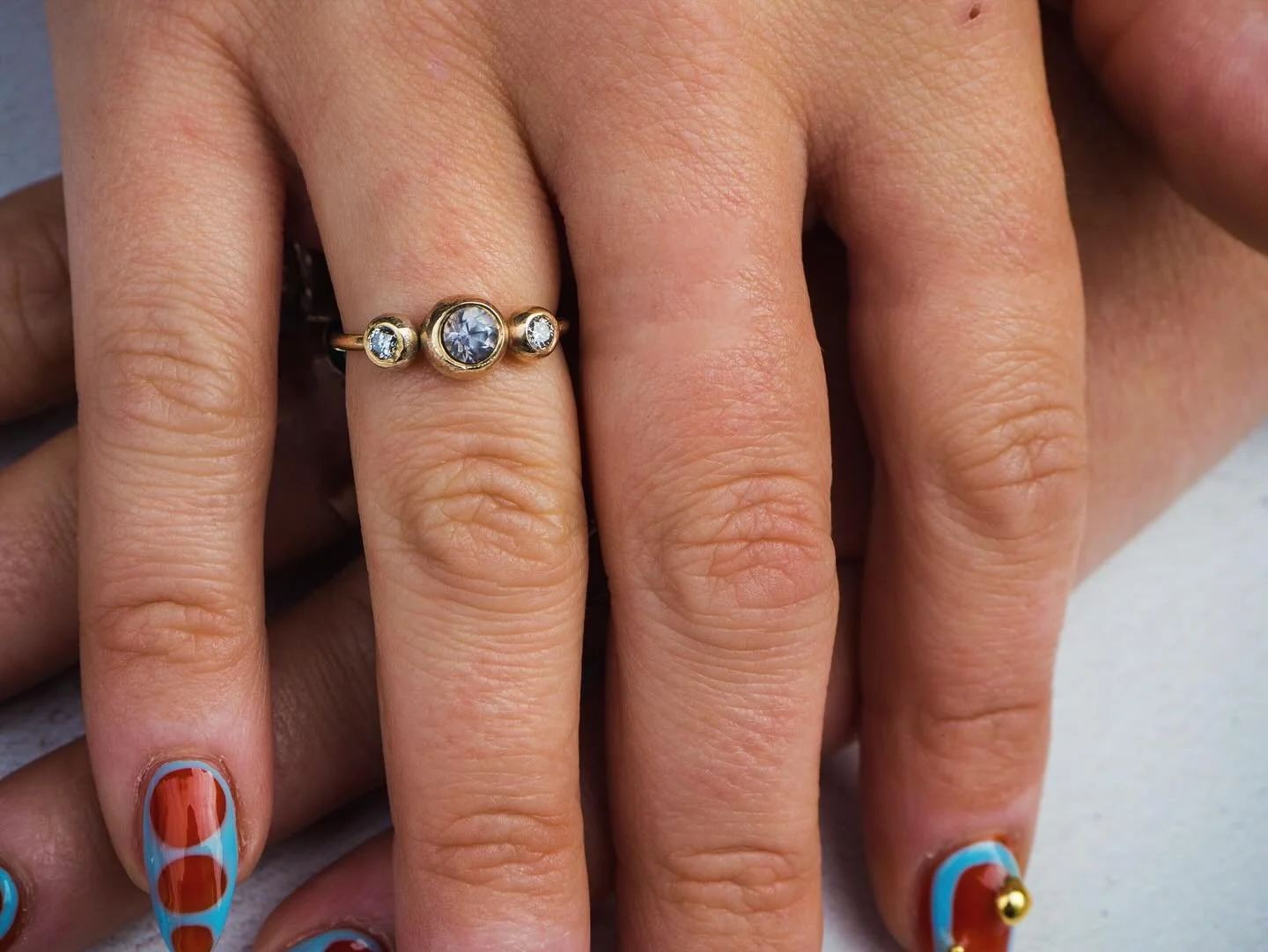 The Trio Ring - white sapphire with a diamond on each side. We have some gorgeous pieces in store ready to go but custom work makes us 🫠 if you have some old gold at home gathering dust then hit us up - we will make it in something you will wear and