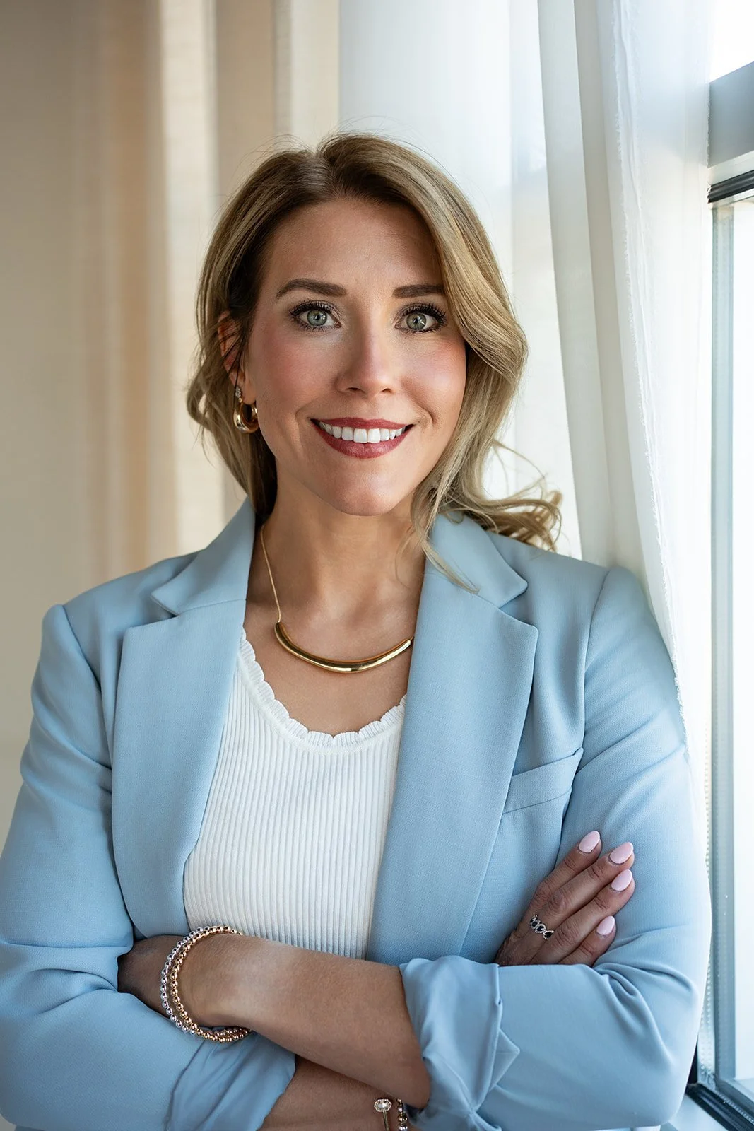 Brittany Baker LCSW, therapist in Denver and Greenwood Village, CO dressed in professional clothing and smiling