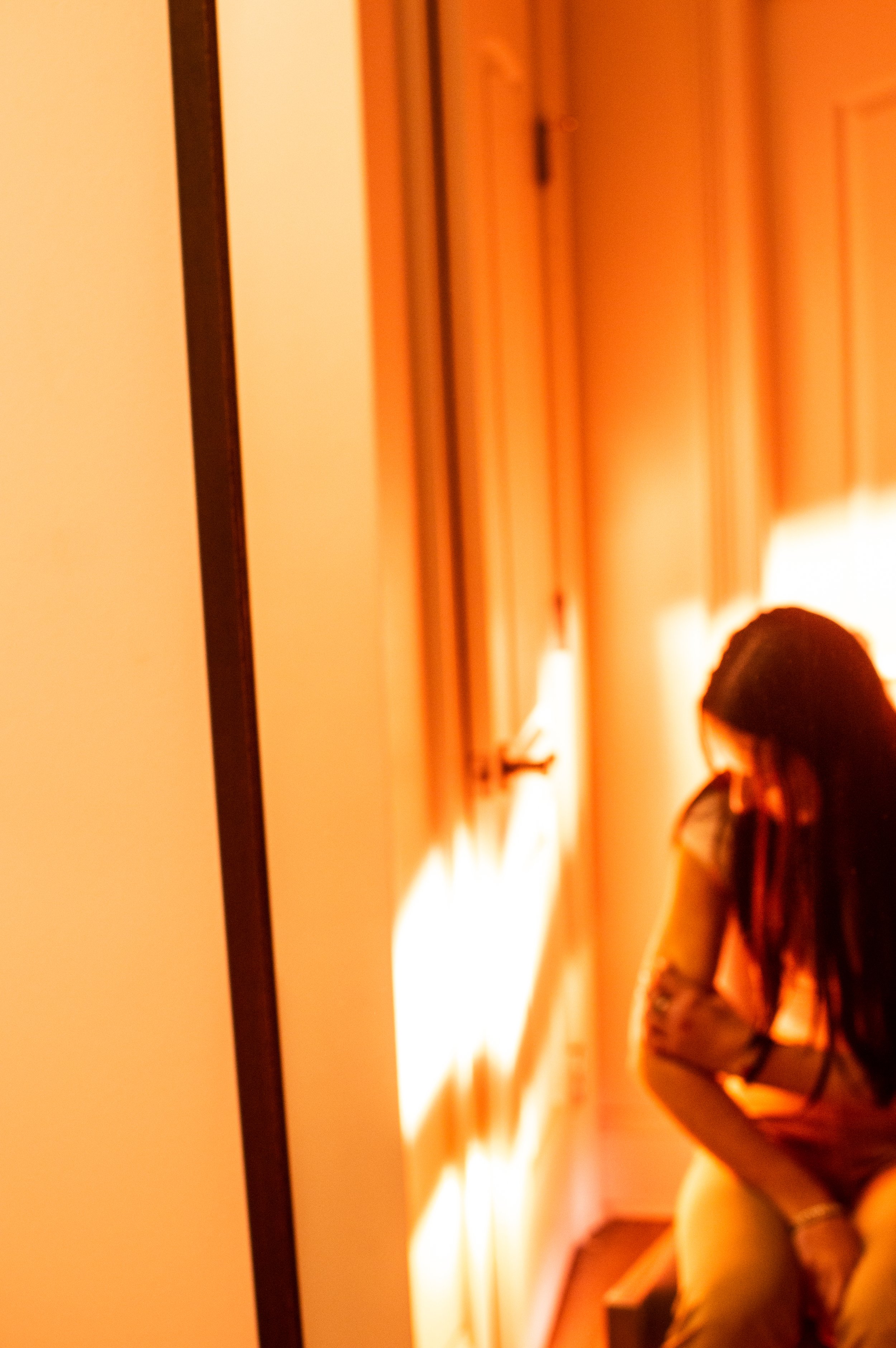 Curled tight in the corner, clutching only the parts of herself she has left. Mourning the girl she used to be, before the violence tore through her life, and before the institution erased her.